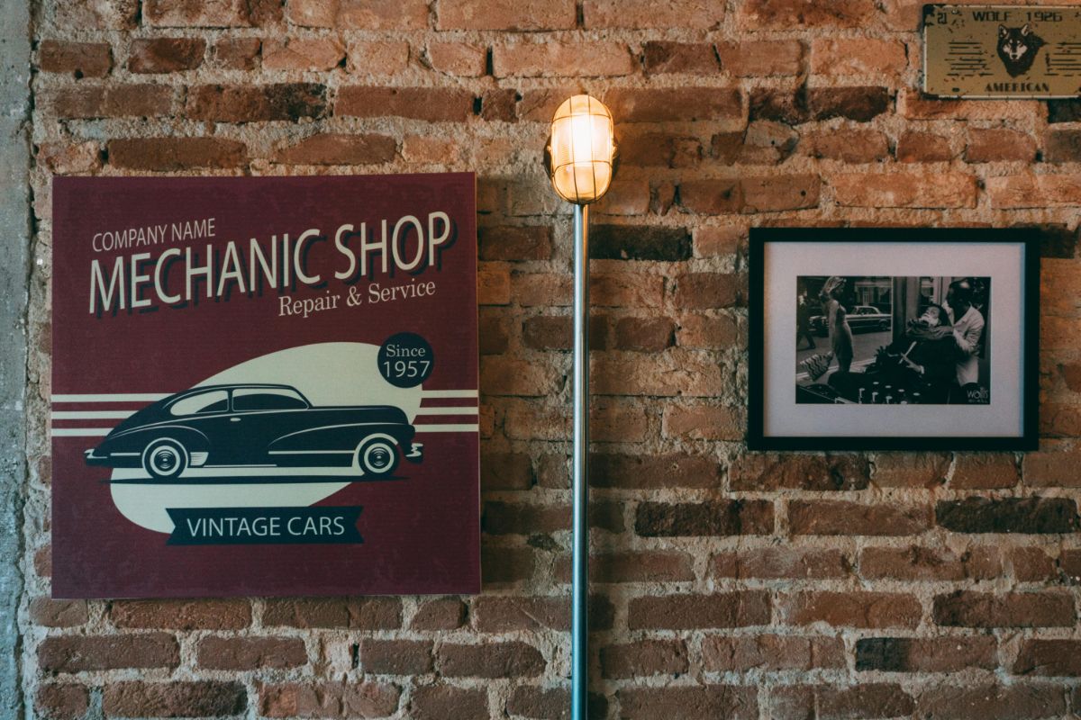 Mechanic shop wall decor beside sconce