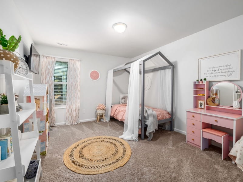 A toddler room with different furniture and a window