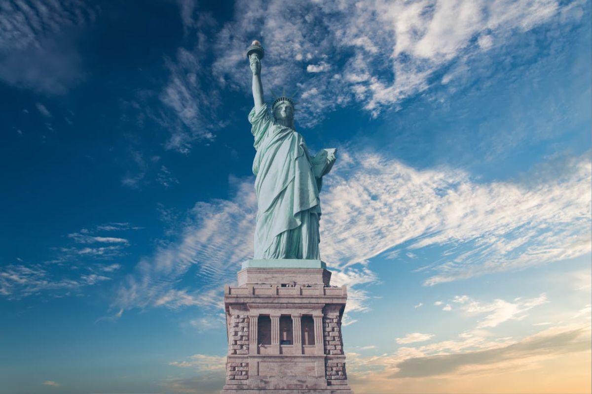 A statue of Liberty with clouds in the sky