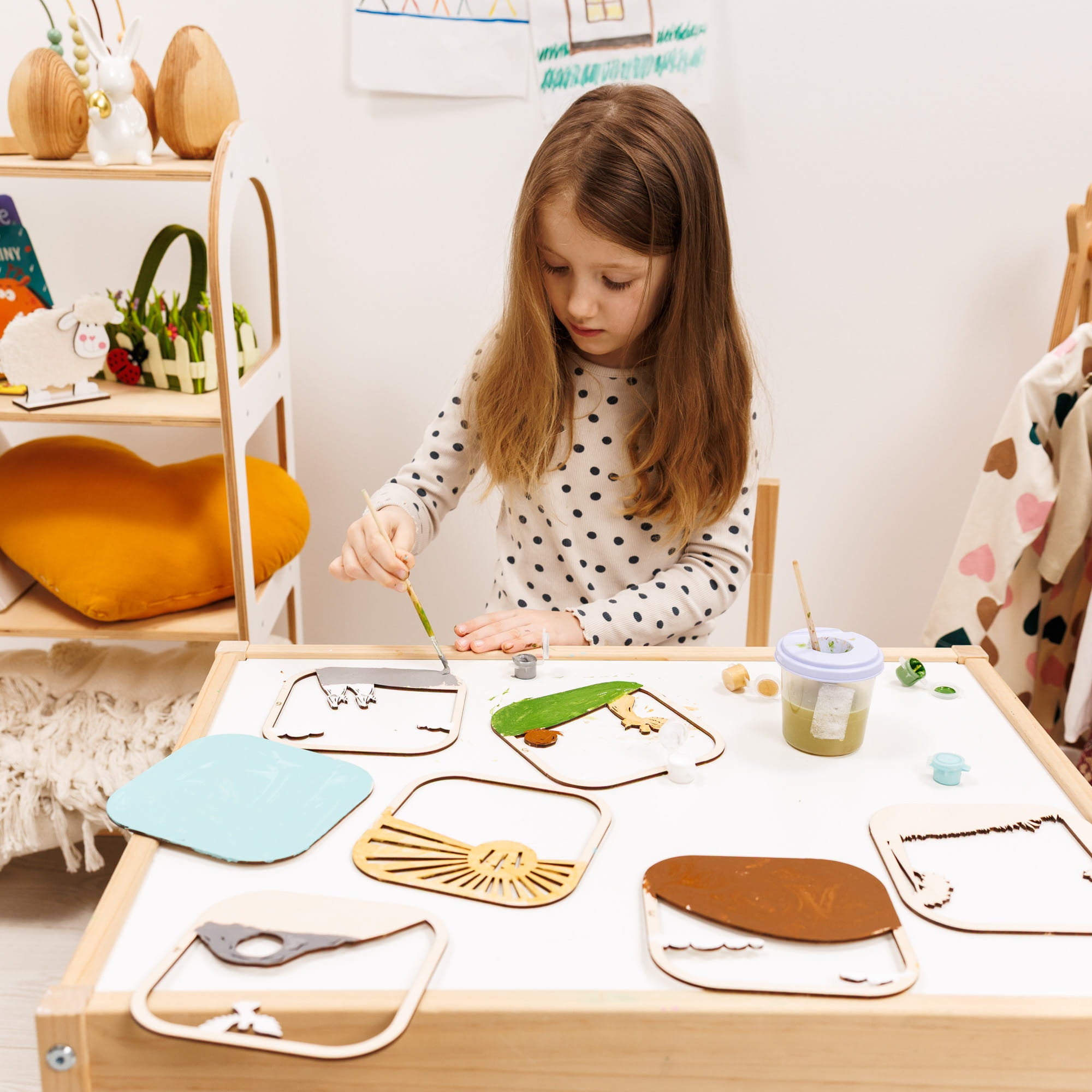 Child engaged in a craft activity at a table with various materials