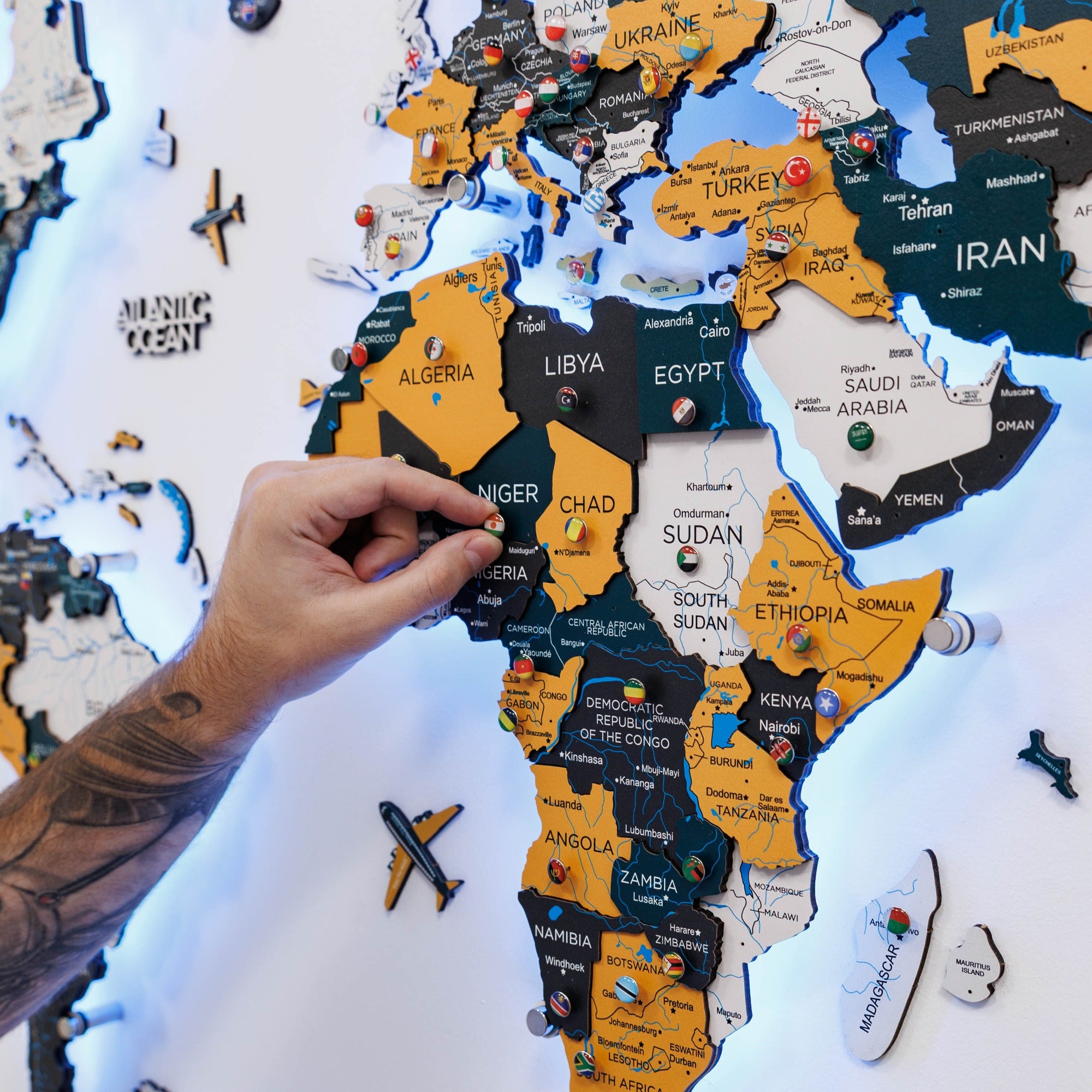 Map of Africa with a hand placing a puzzle piece on it