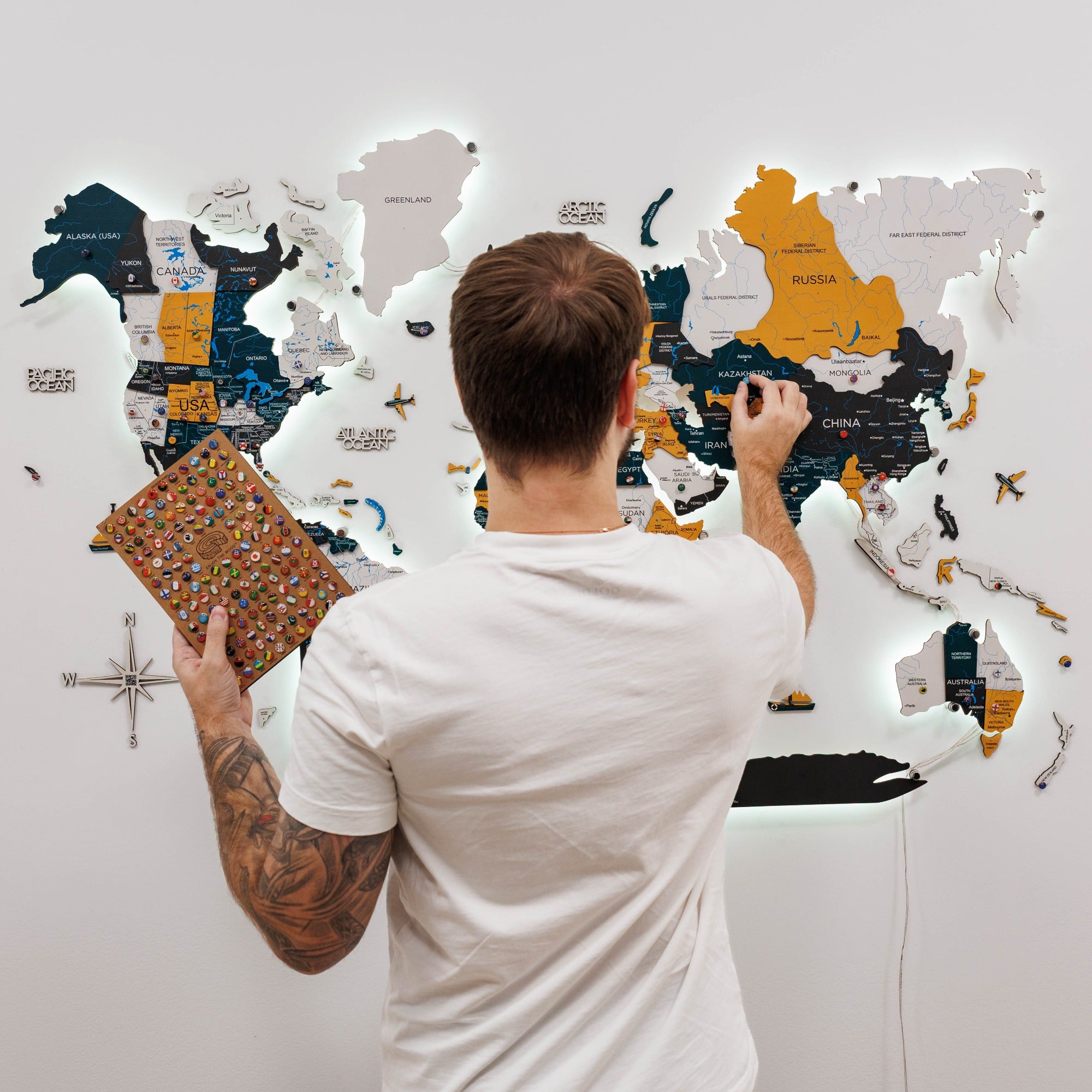 Man interacting with a world map on a wall