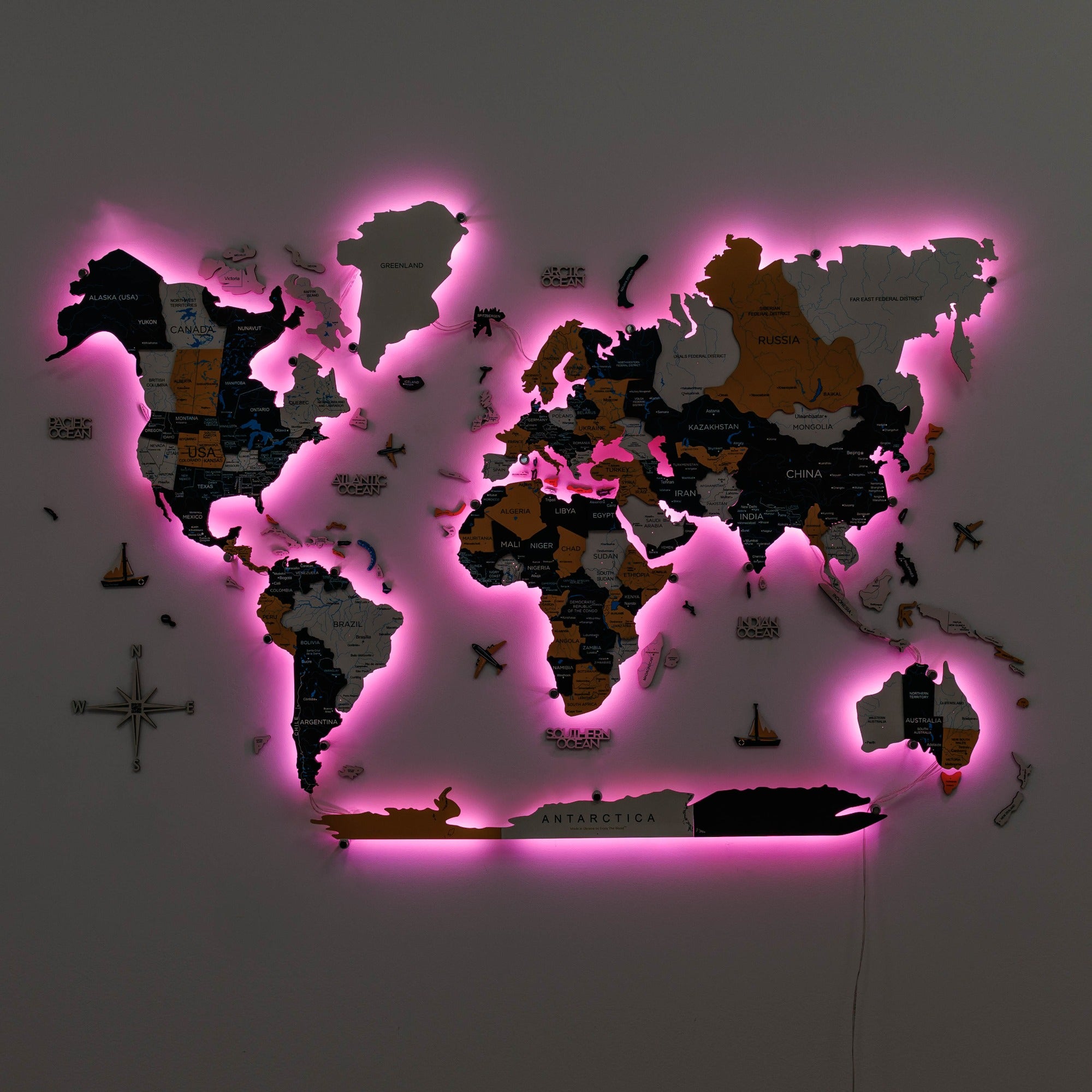 World map with pink LED lighting on a dark background