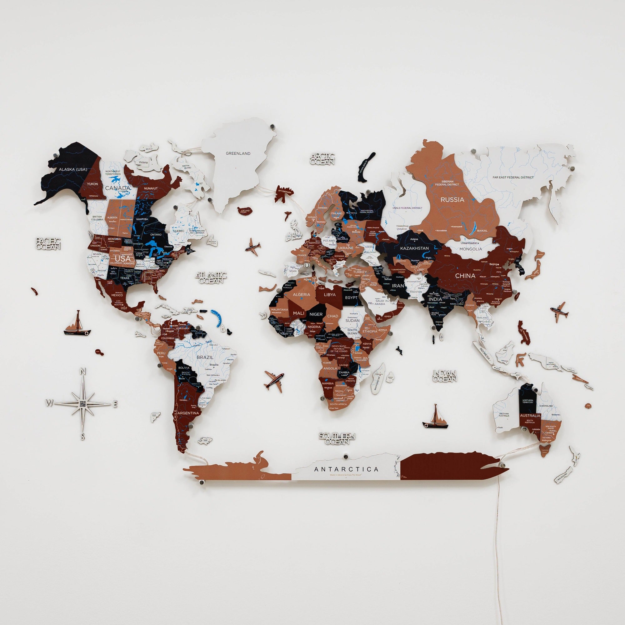 World map with wooden cutout sections on a white background