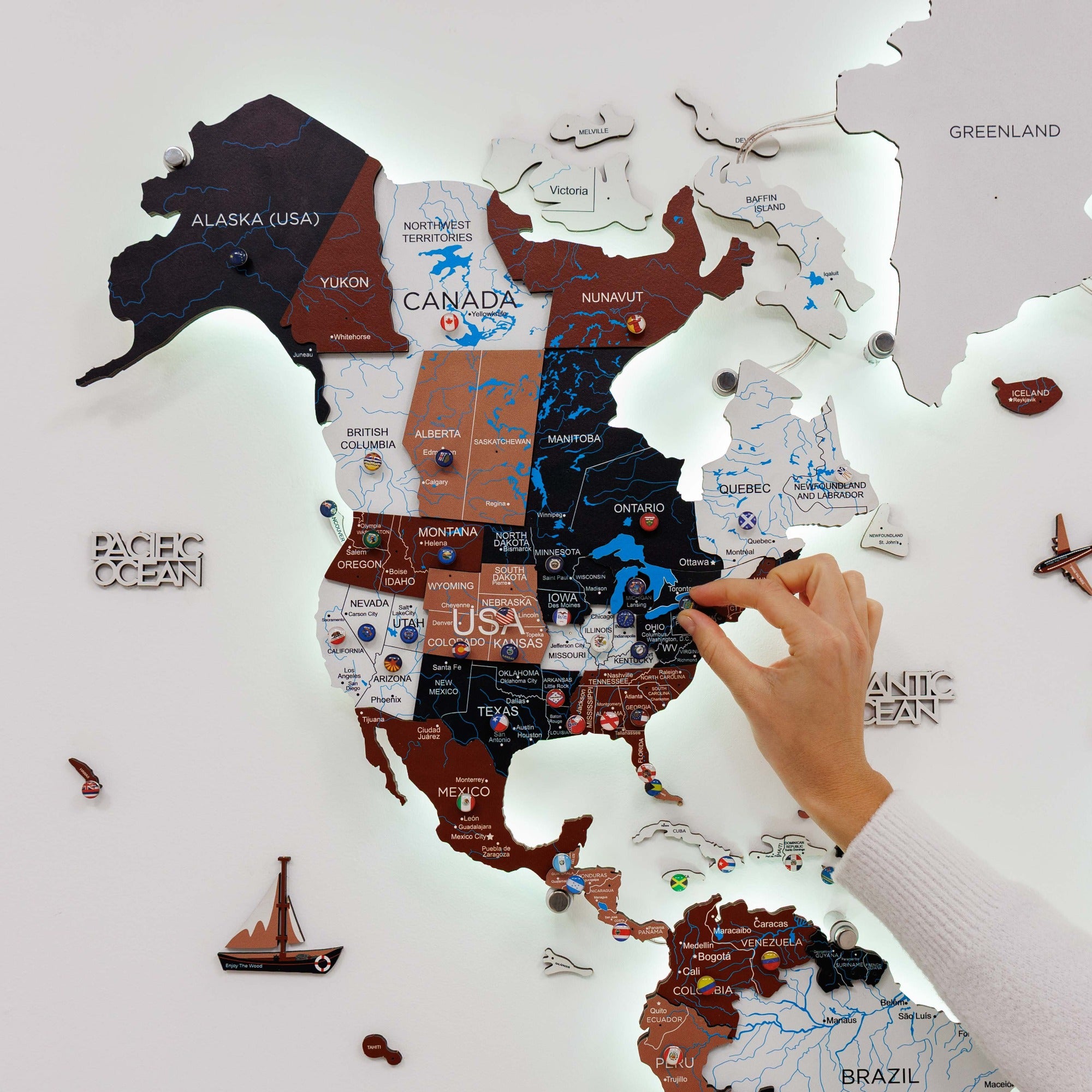 Map of North America with a hand pointing to a location on the map.