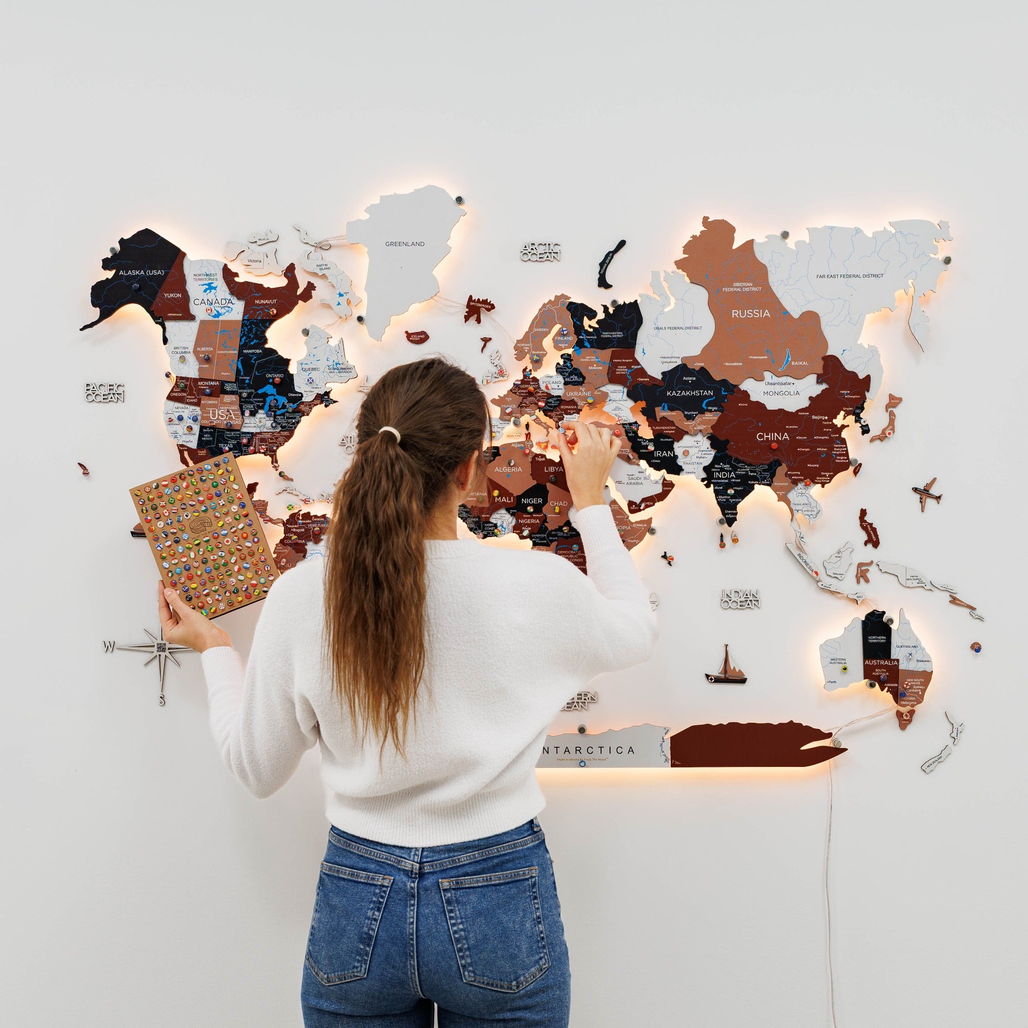 Person interacting with a world map on a wall