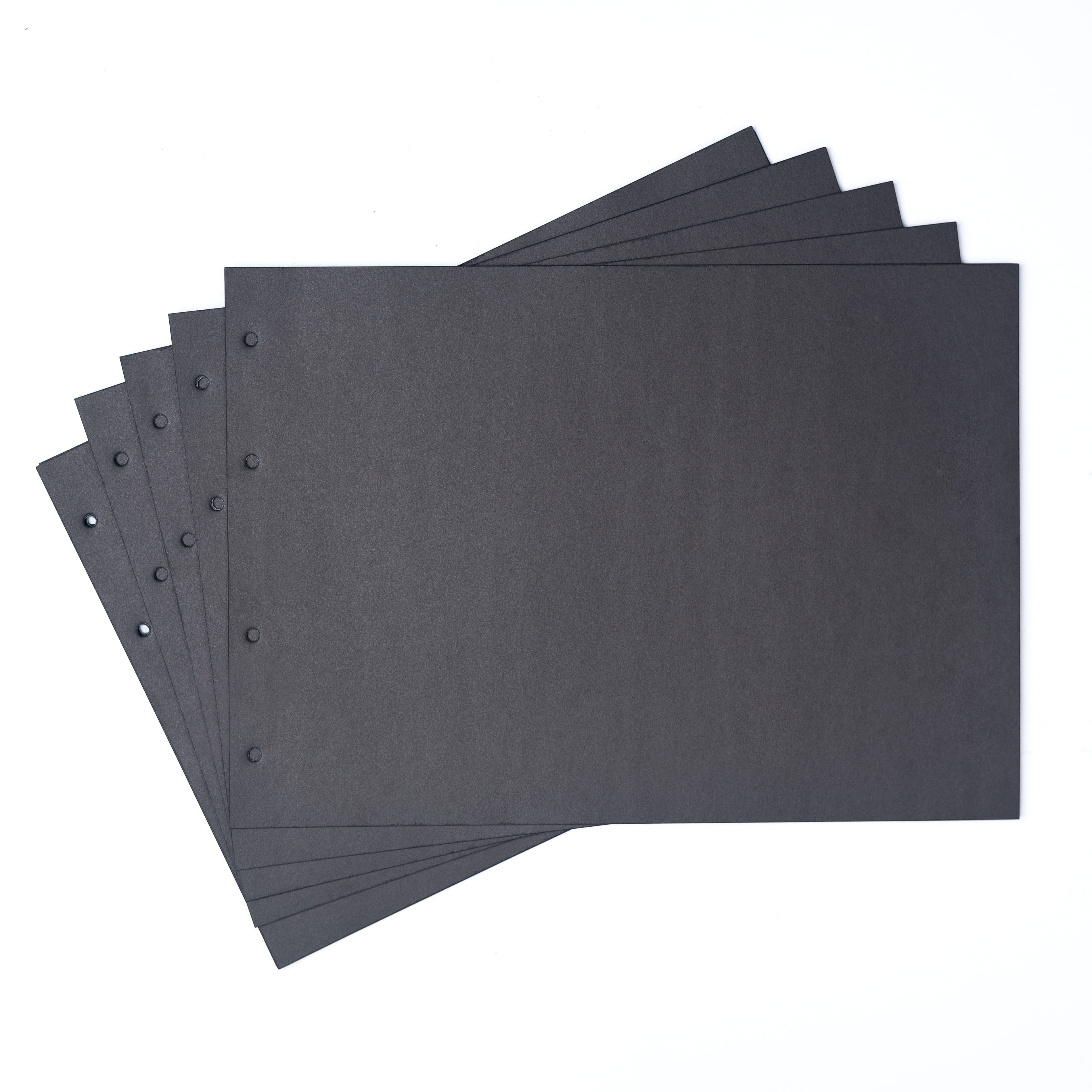Stack of black sheets with holes on a white background