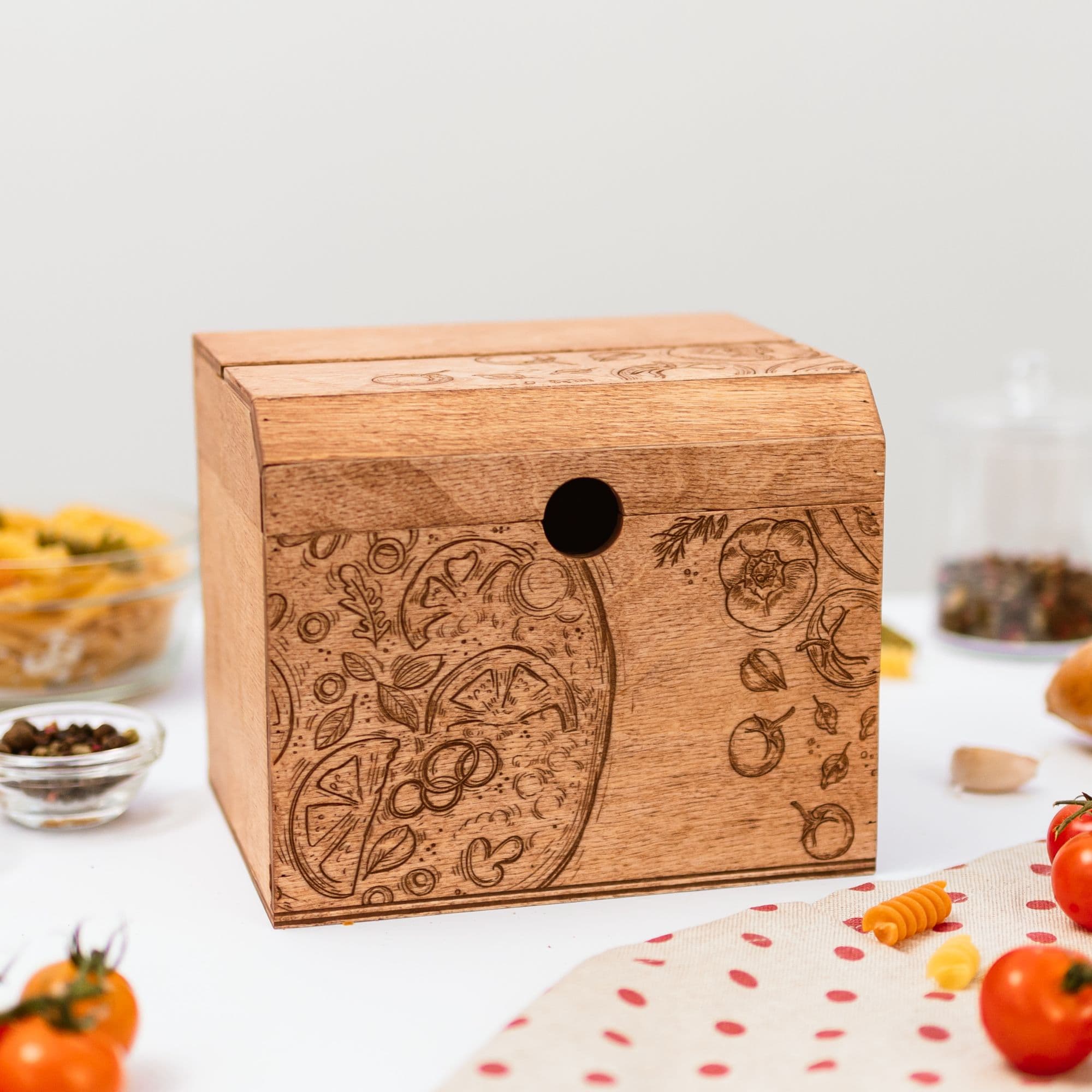 A wooden recipe box with a pizza-inspired design, placed on a kitchen countertop surrounded by ingredients and recipe cards.