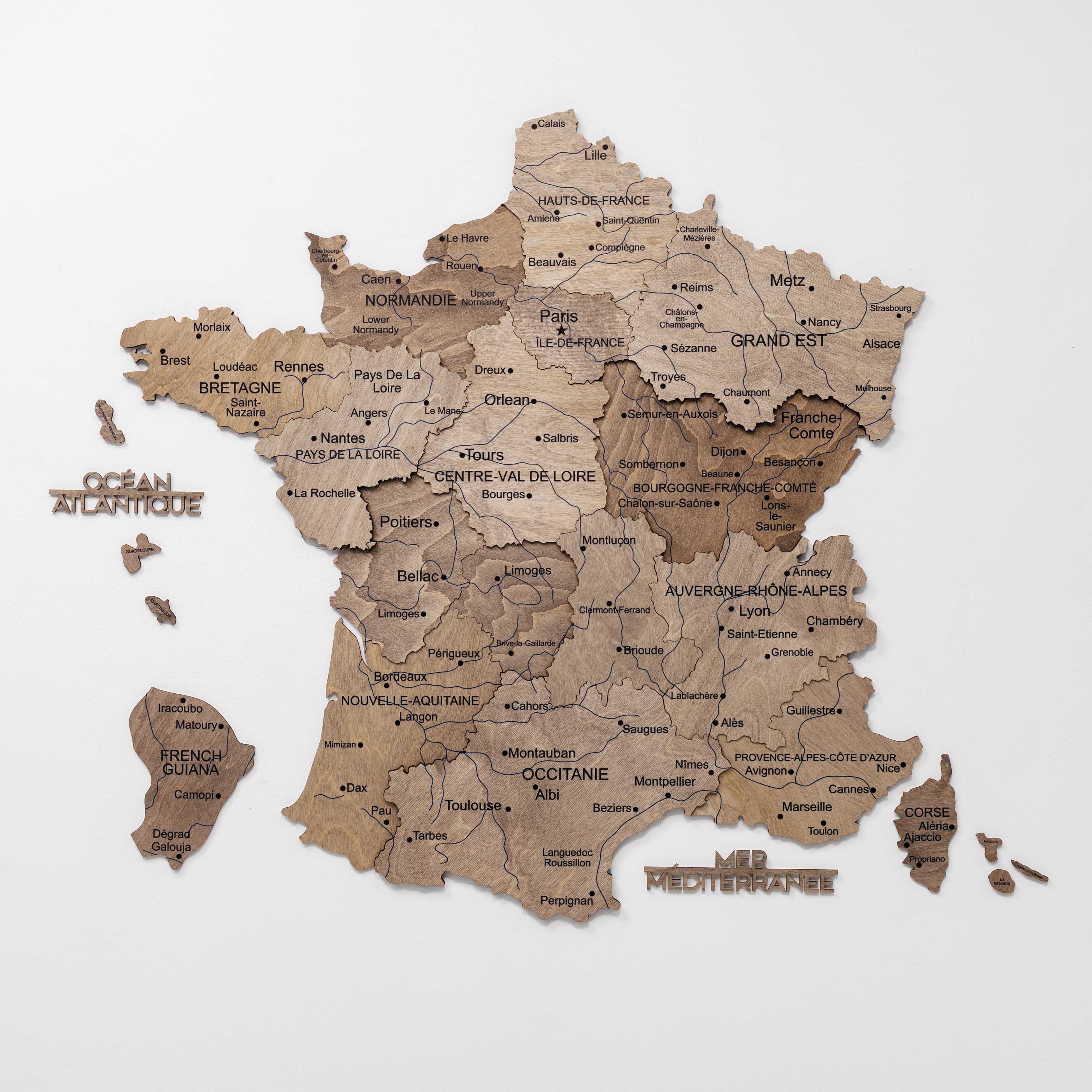 Wooden map of France with regions labeled on a white background