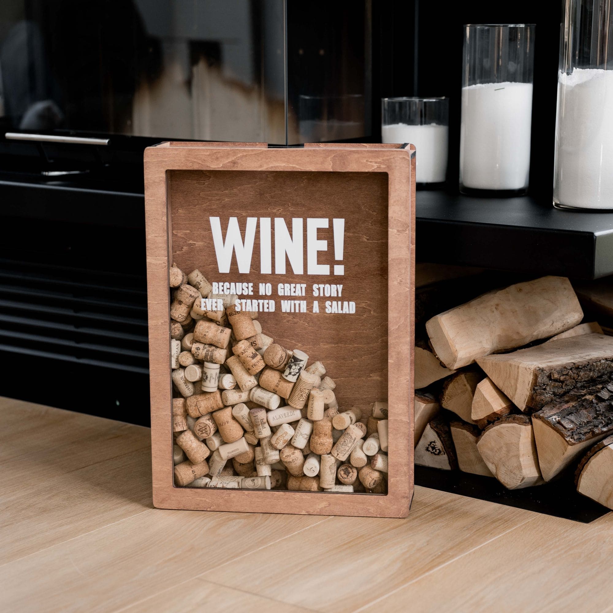 Brown wooden wine cork holder box filled with corks placed near fireplace and candles
