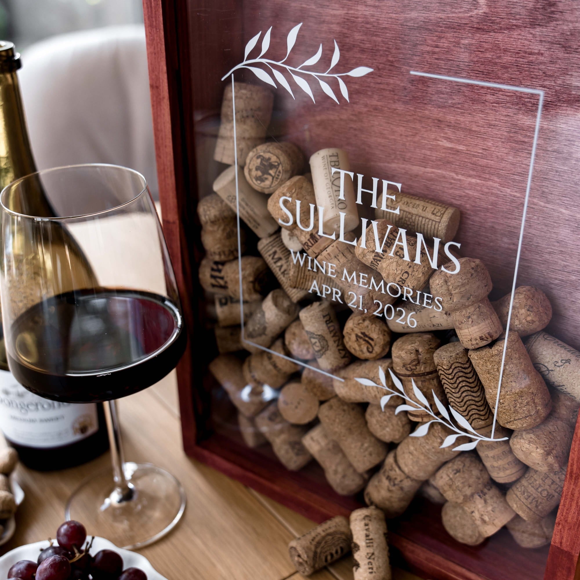 A personalized wooden wine memory box with a clear front panel