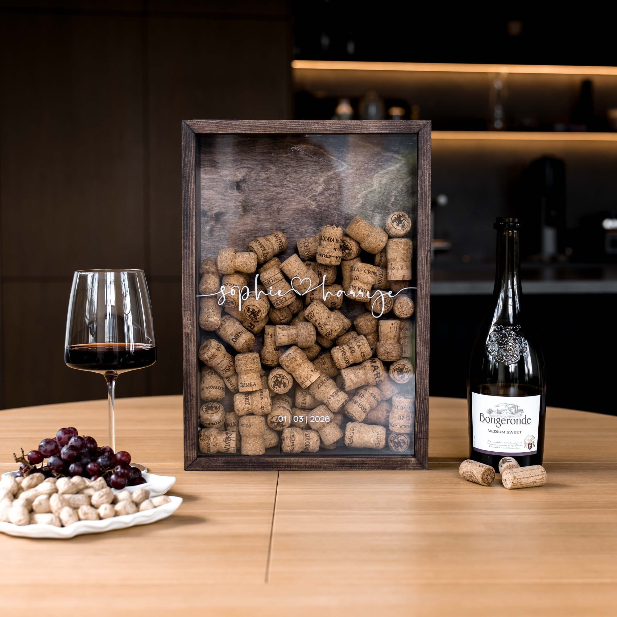 A personalized wooden wine cork display frame on a wooden table