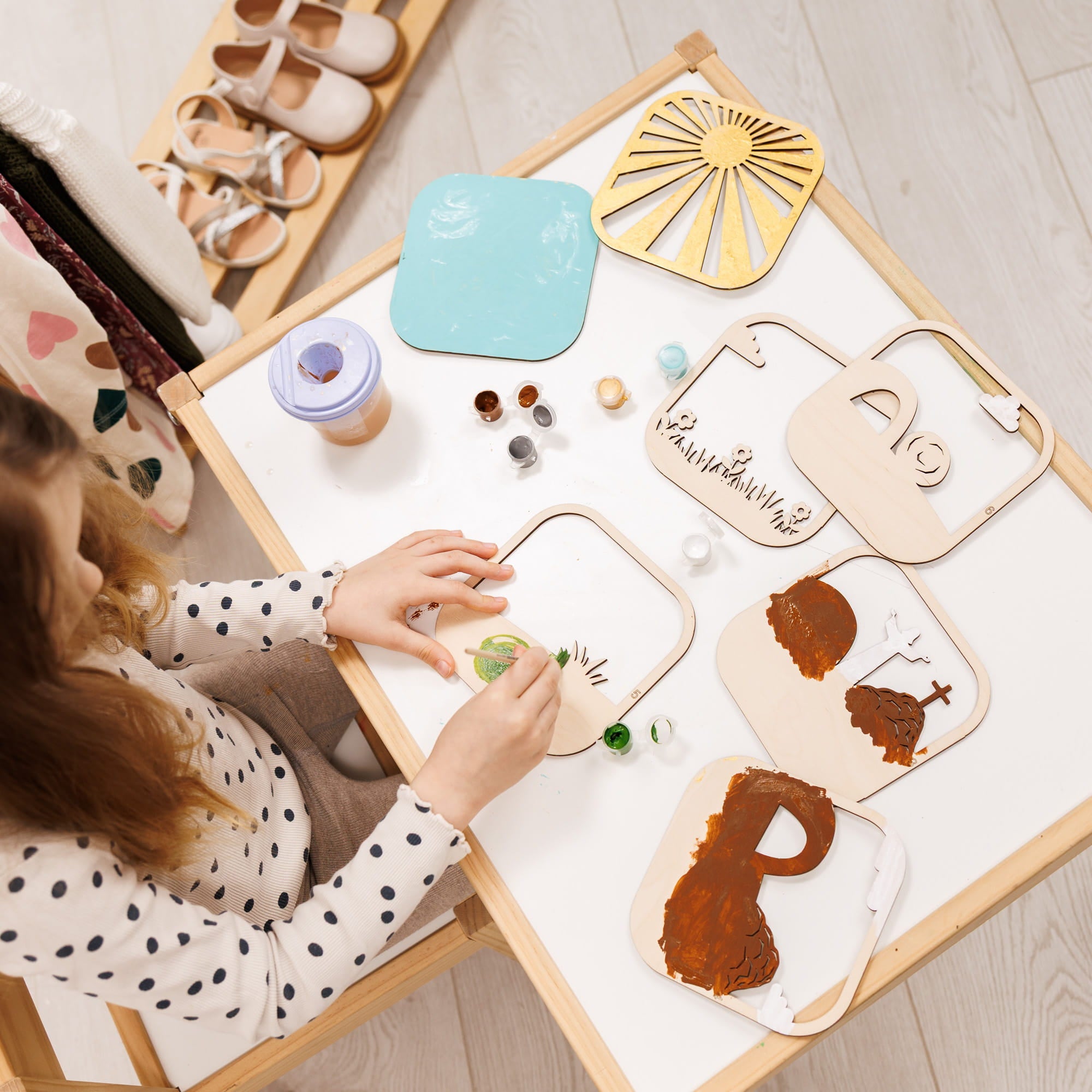 Child playing with wooden toys on a table