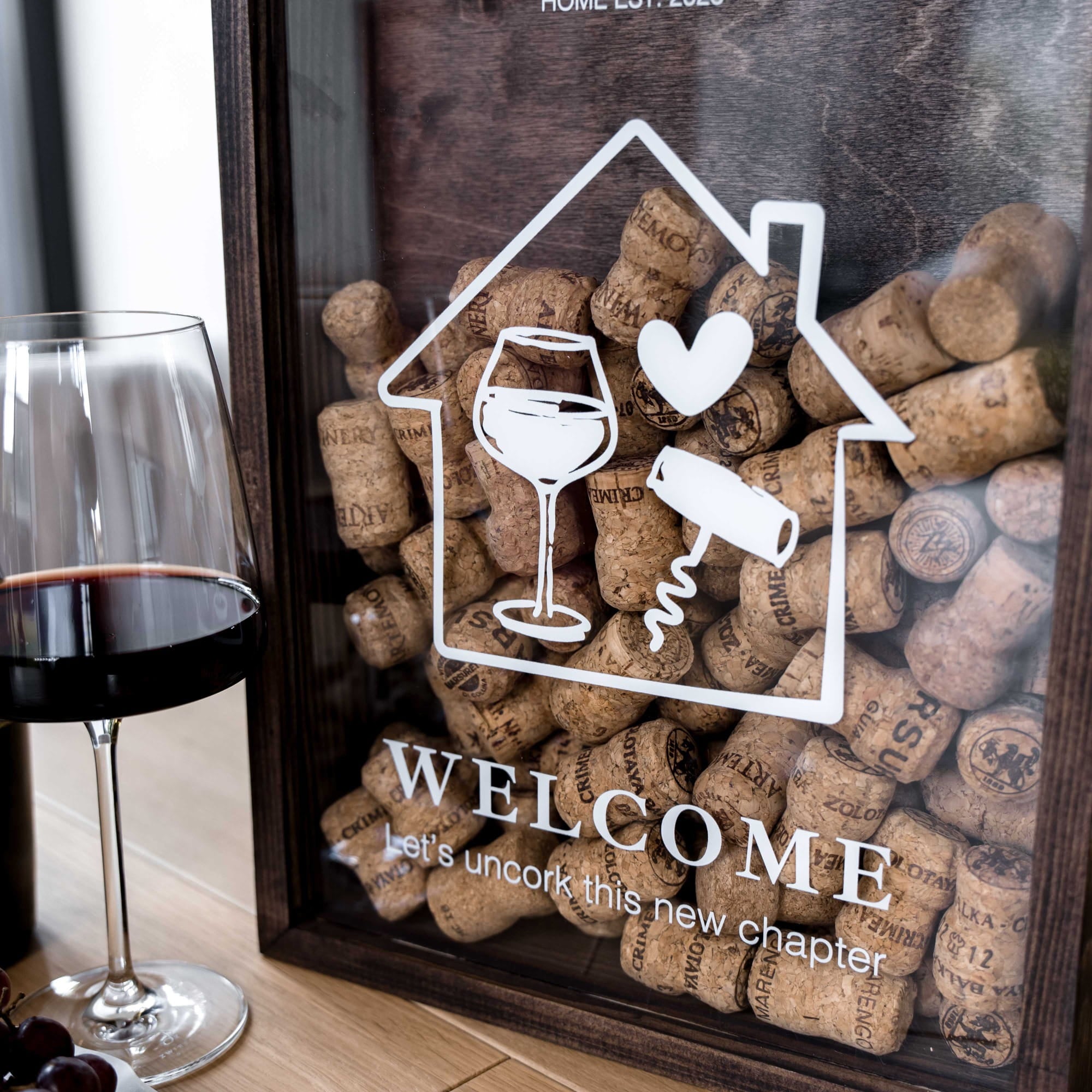 A personalized wooden wine-themed framed sign on a wooden table