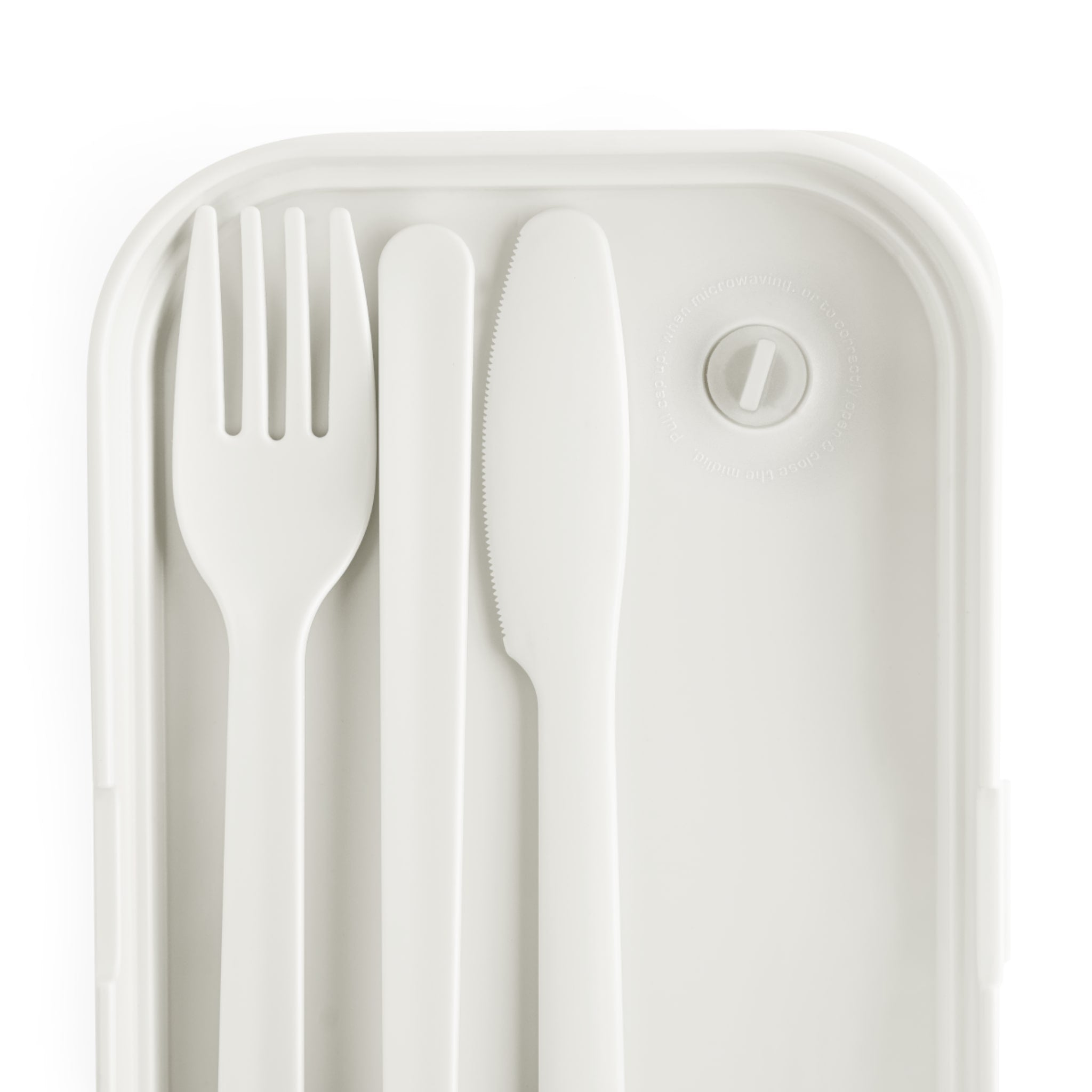 White plastic fork and knife set in a transparent plastic case on a white background