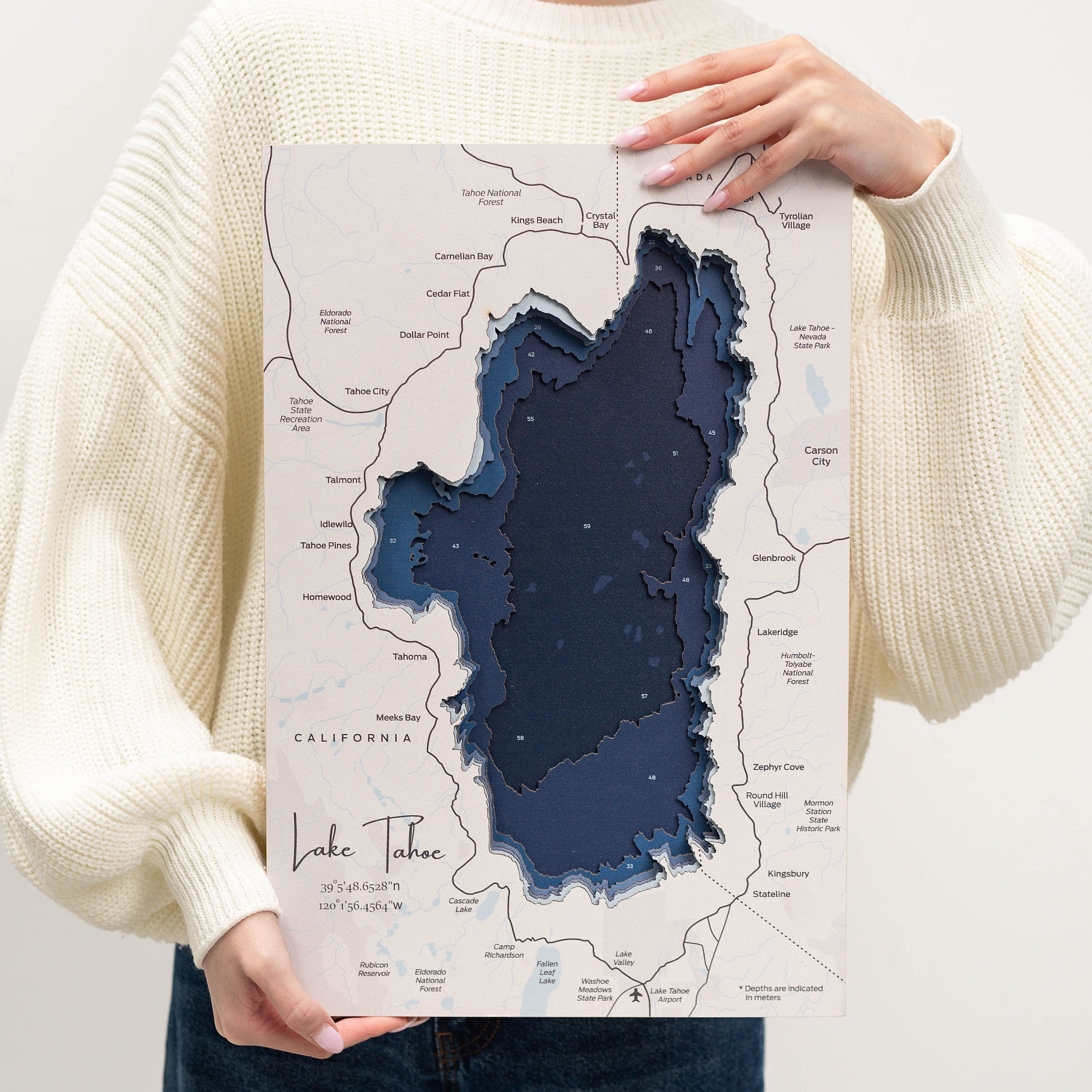 Person holding a map of Lake Tahoe with a 3D effect