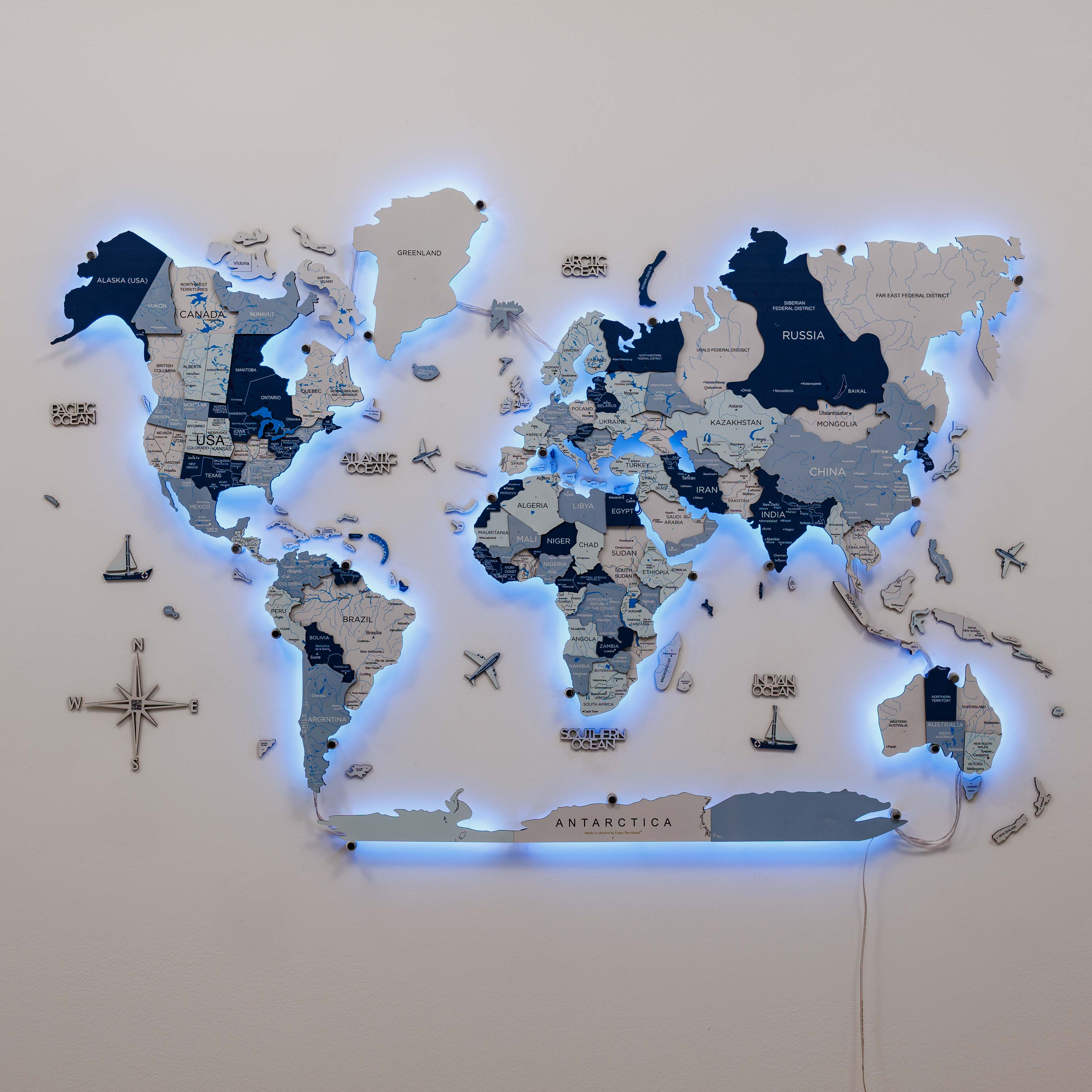 World map with illuminated edges on a white wall