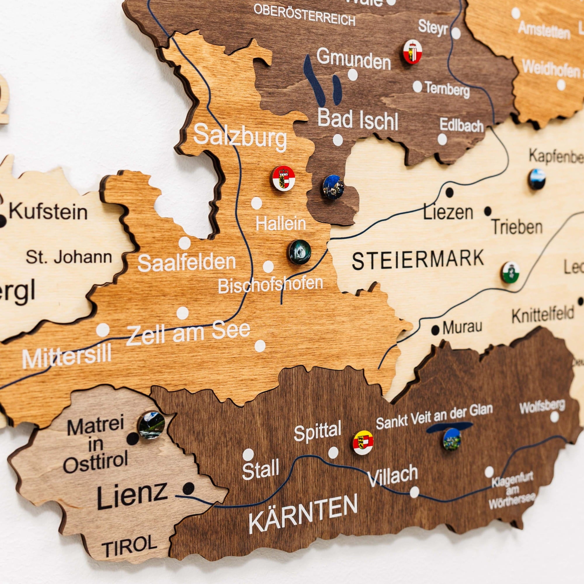 Wooden map of Austria with various locations marked by pins.
