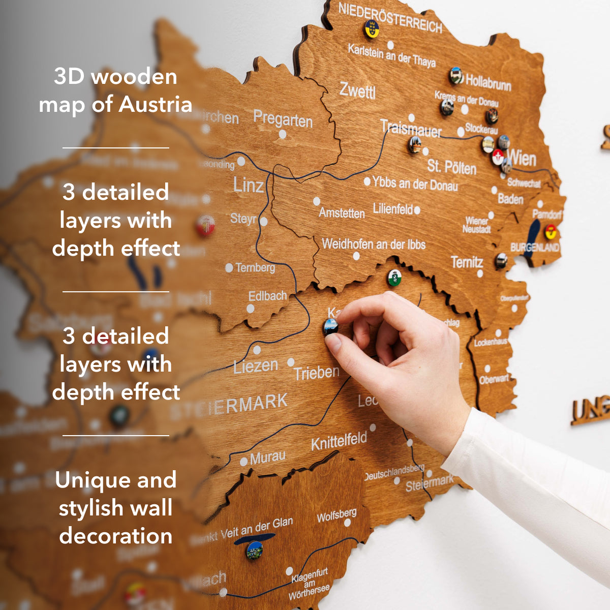 Wooden map of Austria with a hand pointing to a location, text describing features.