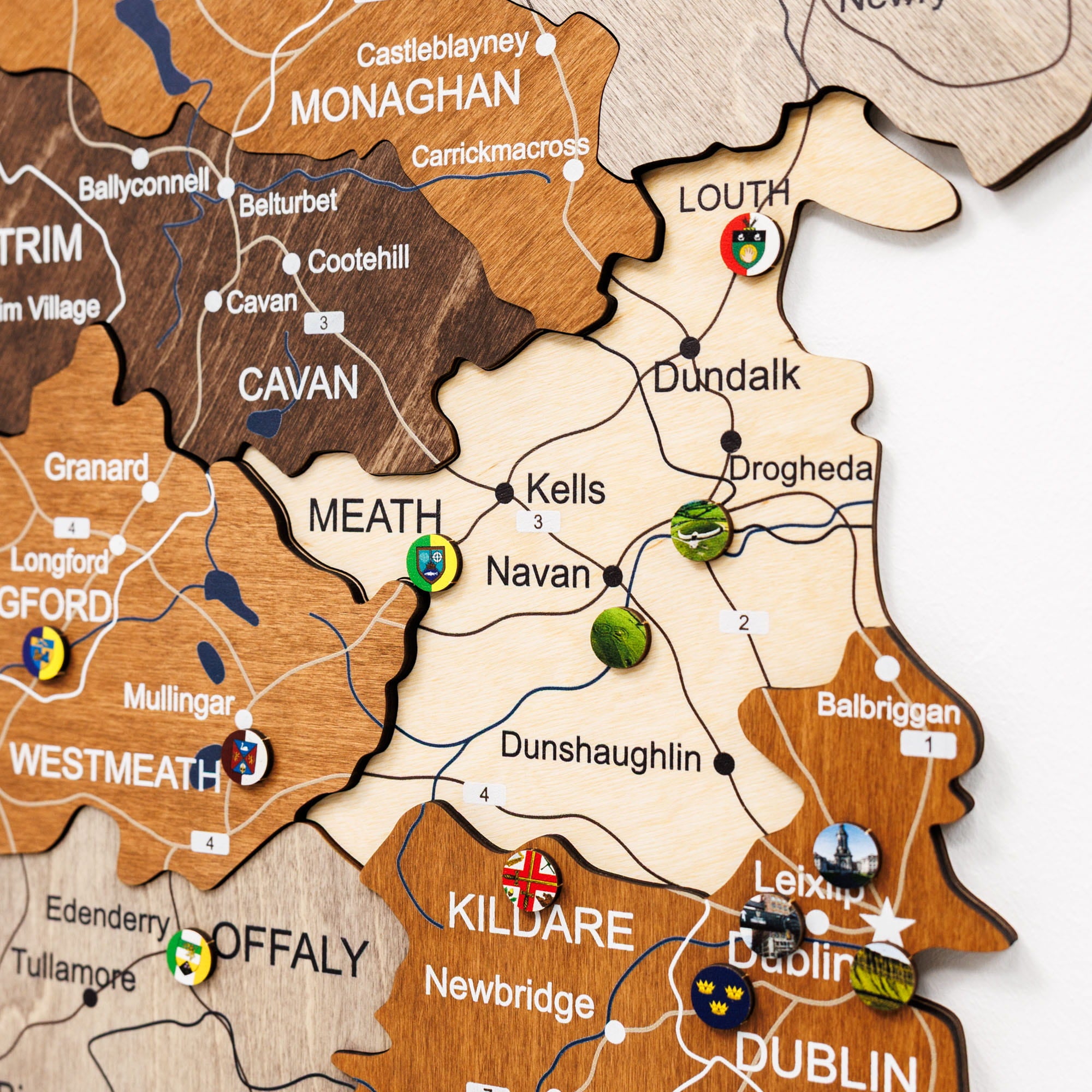 Wooden map of Ireland with various locations marked by pins.