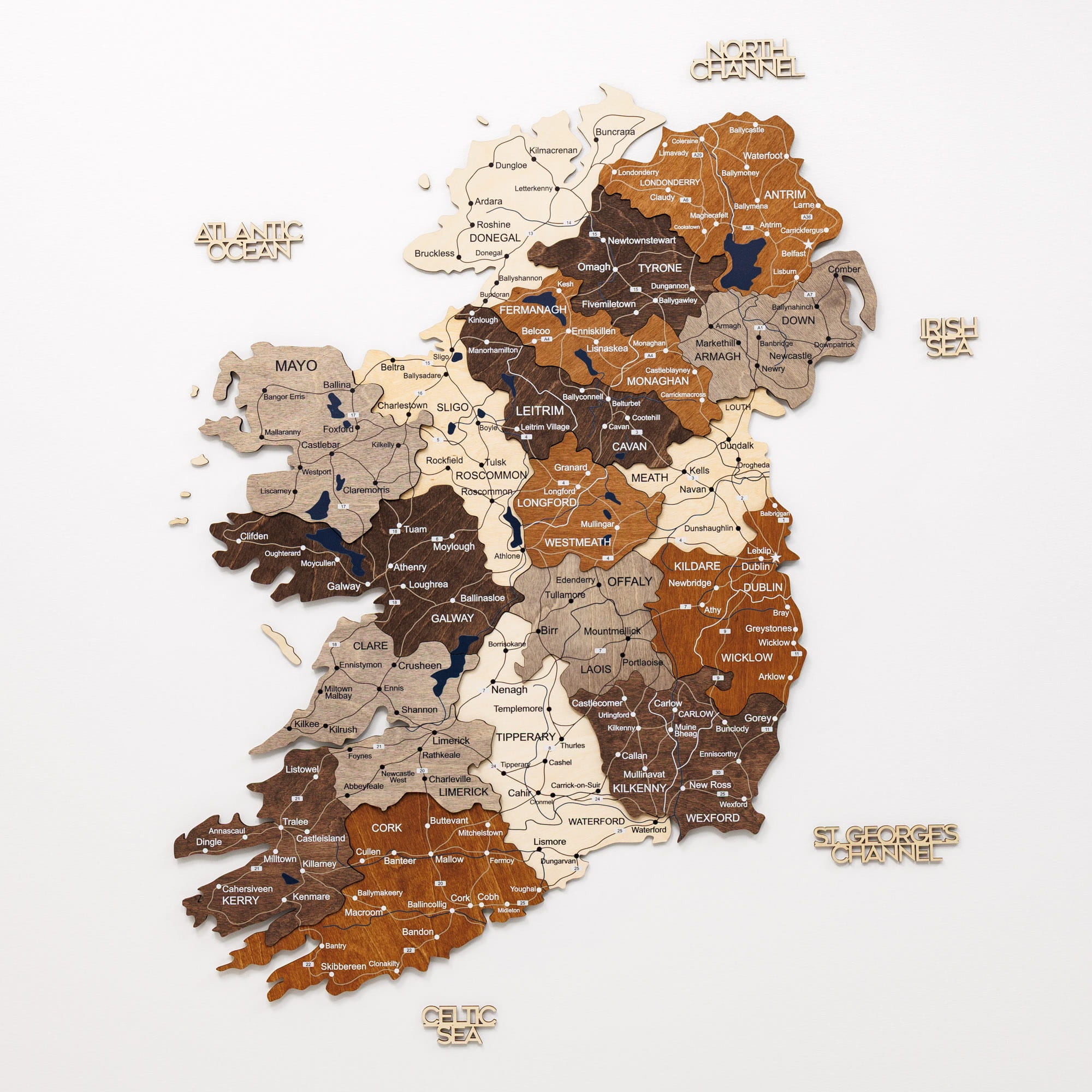 Wooden map of Ireland with counties labeled on a white background