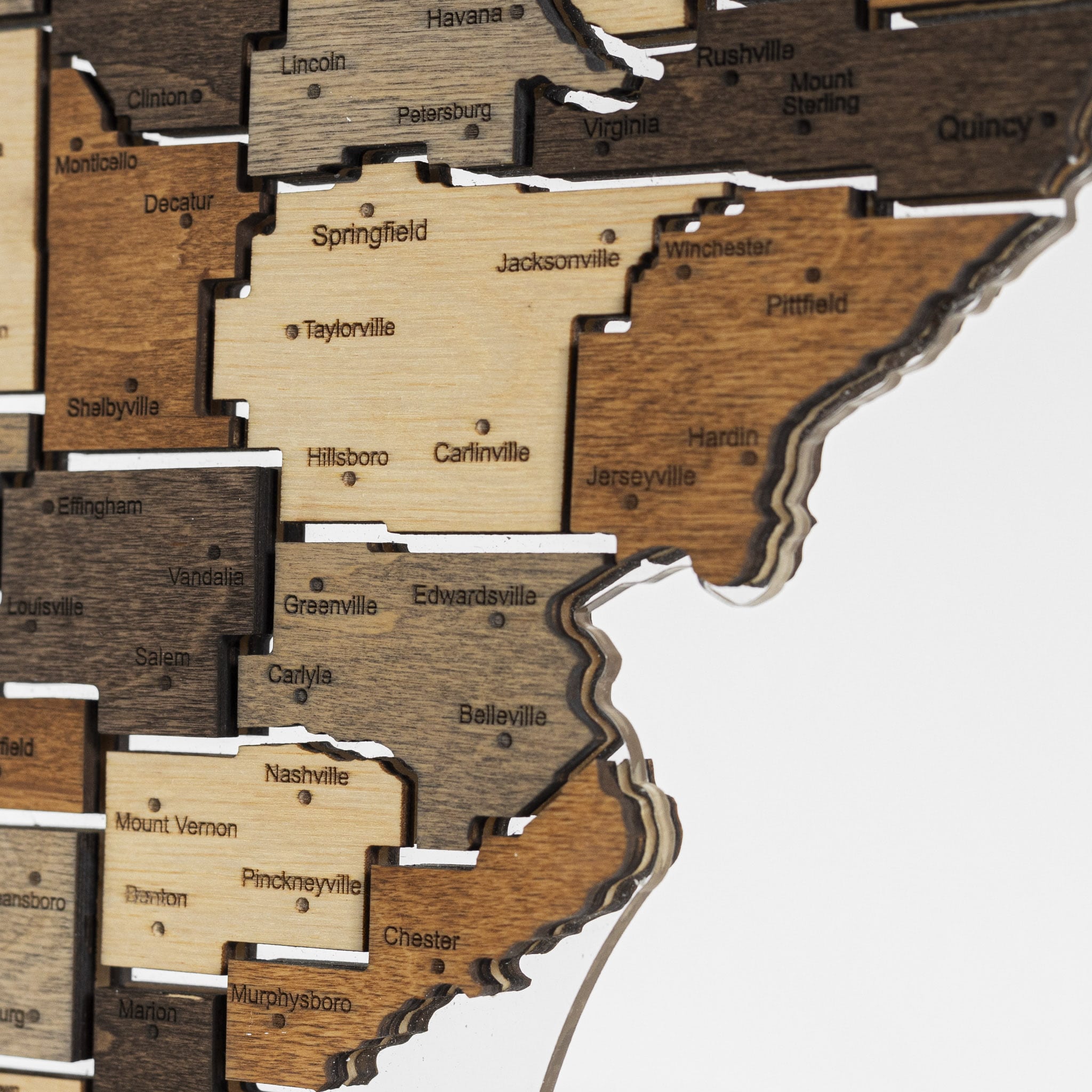 Wooden map of the United States with cities labeled on a white background