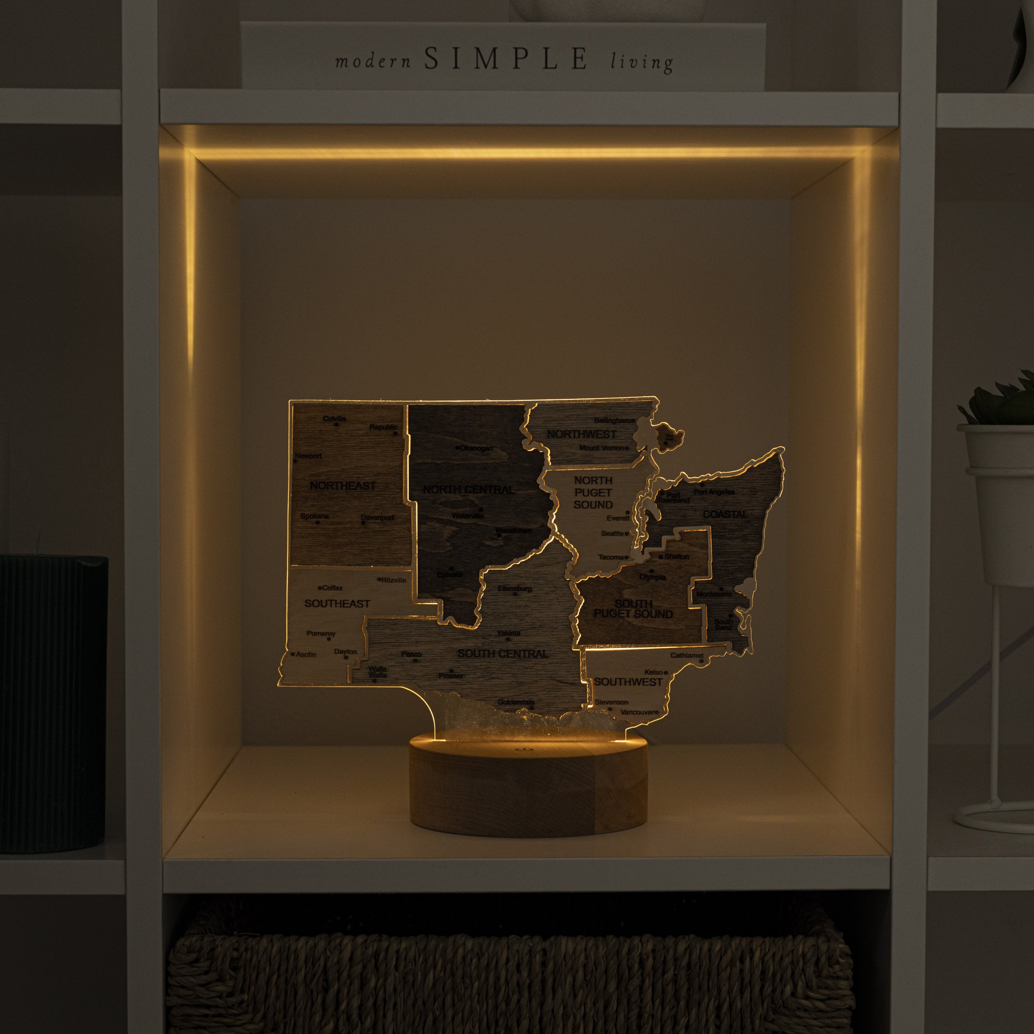 Wooden map of Oregon with LED lighting on a shelf.