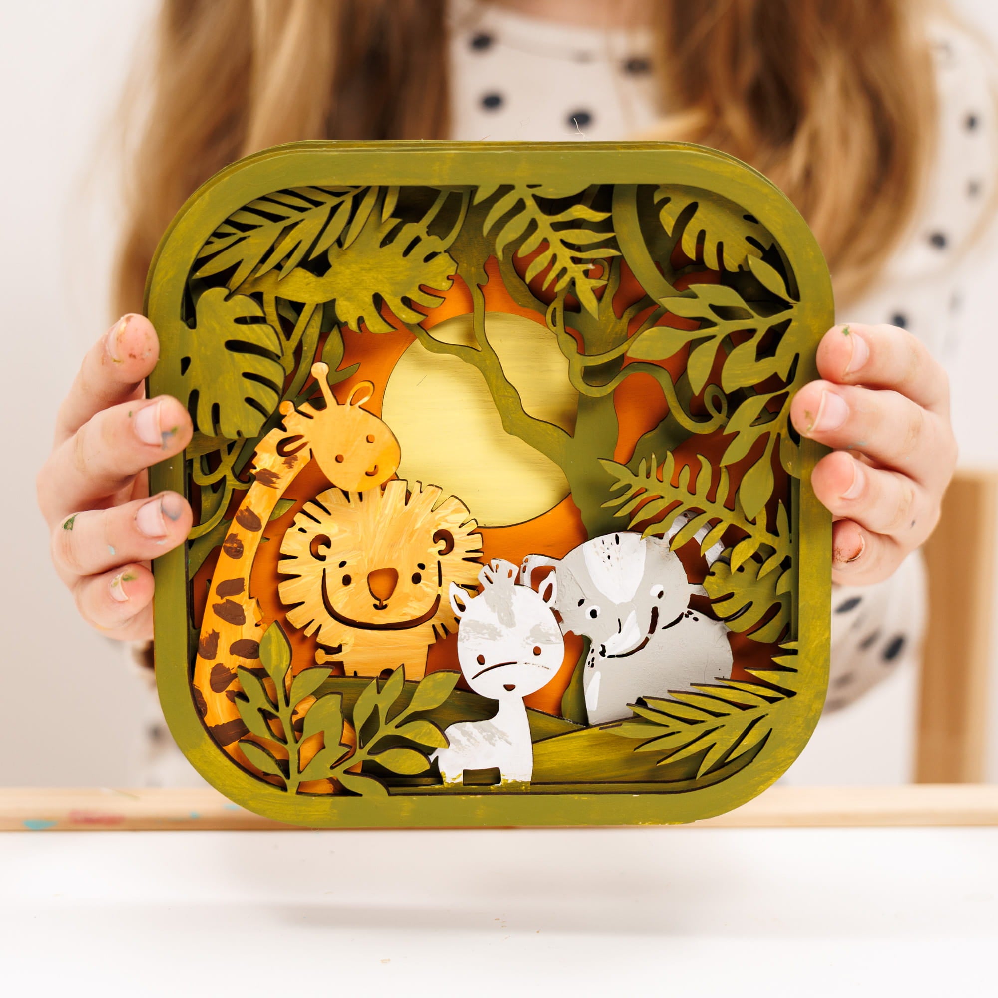 Children's lunch box with 3D animal design held by a person