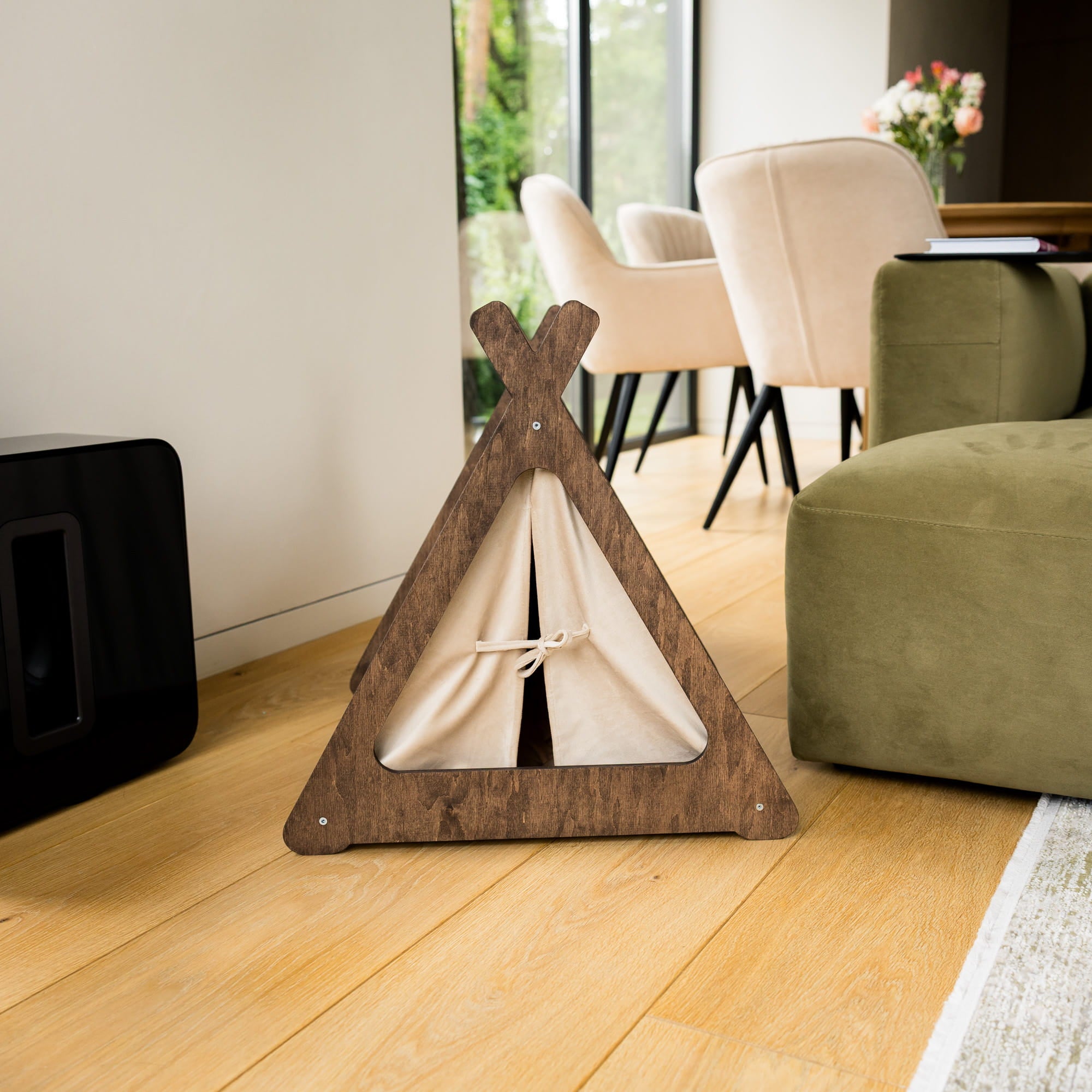 Wooden pet teepee on a wooden floor with a living room in the background