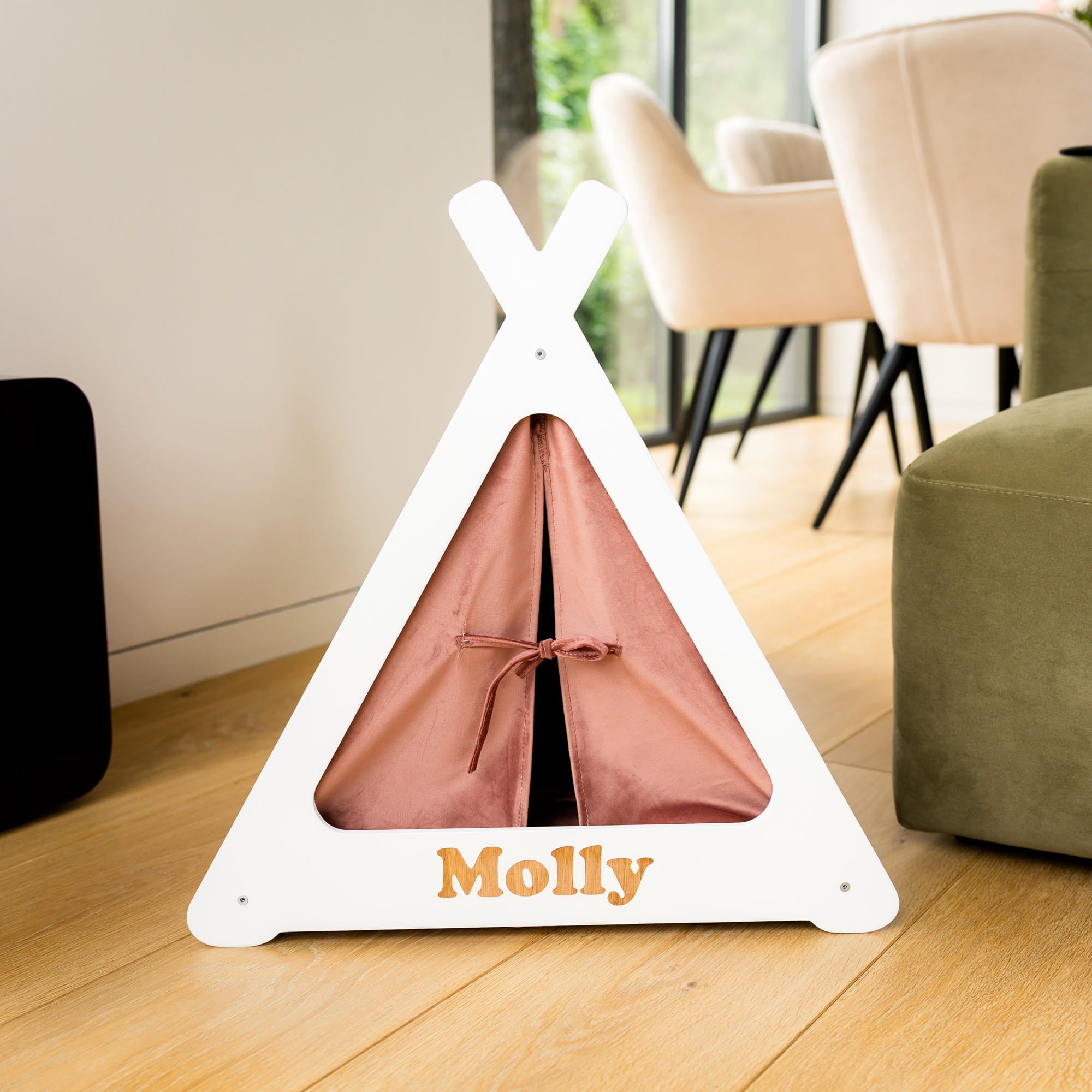 White pet teepee with pink interior and 'Molly' branding on a wooden floor.