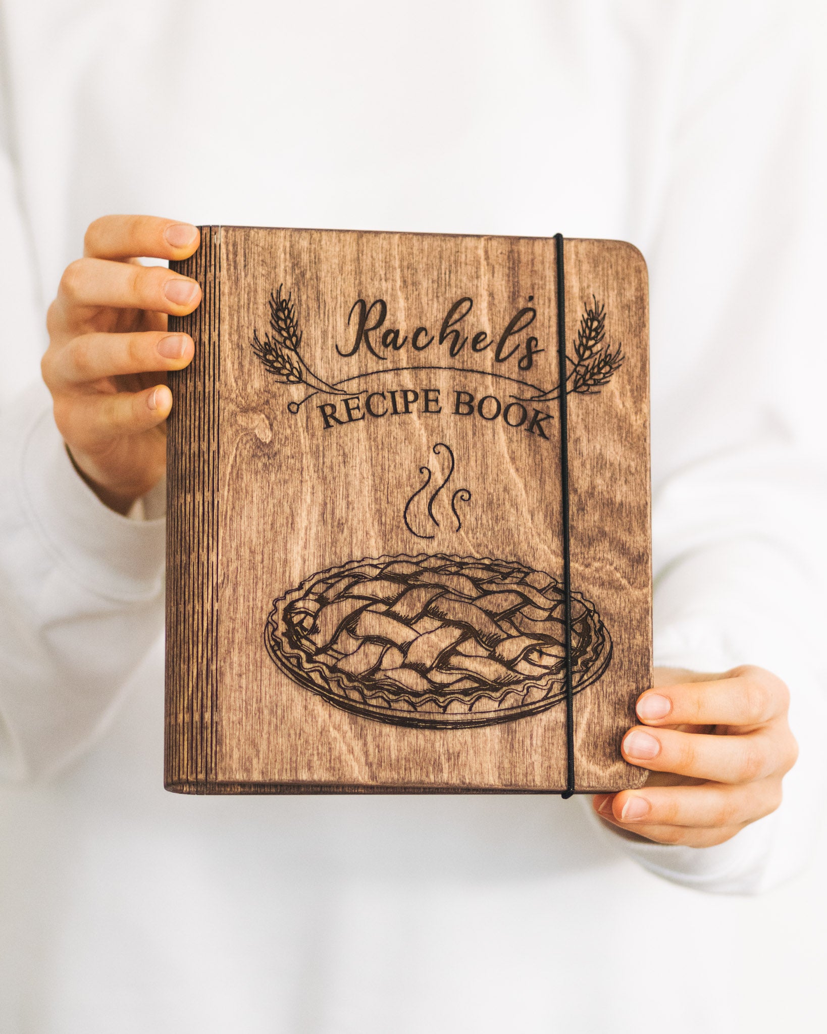 Rustic wooden recipe book with engraved name on cover