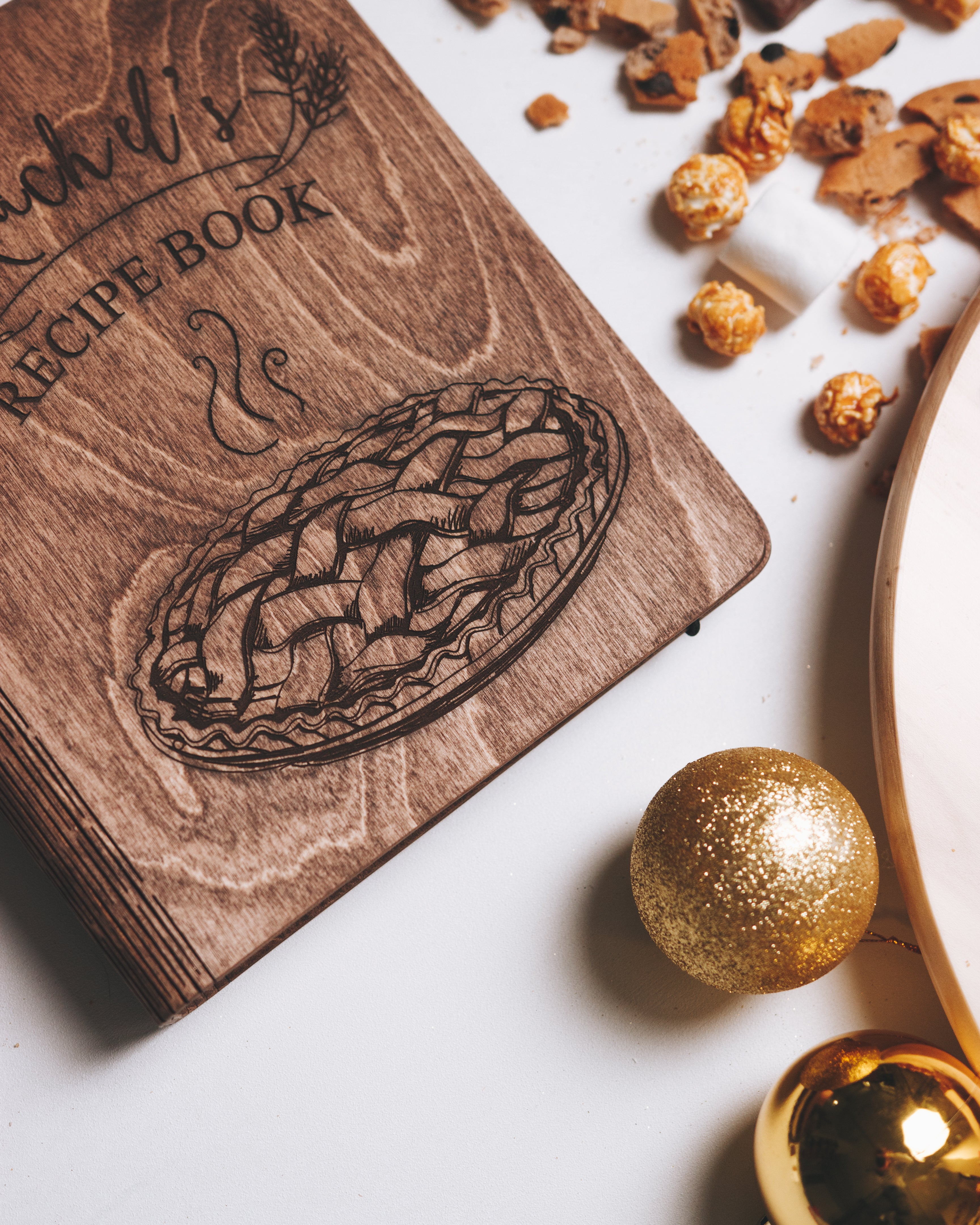 Rustic engraved wooden recipe book with Christmas decorations