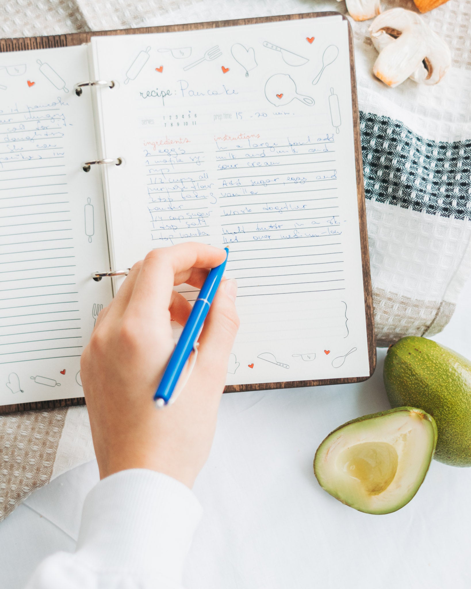 Open recipe notebook with handwritten notes and food illustrations