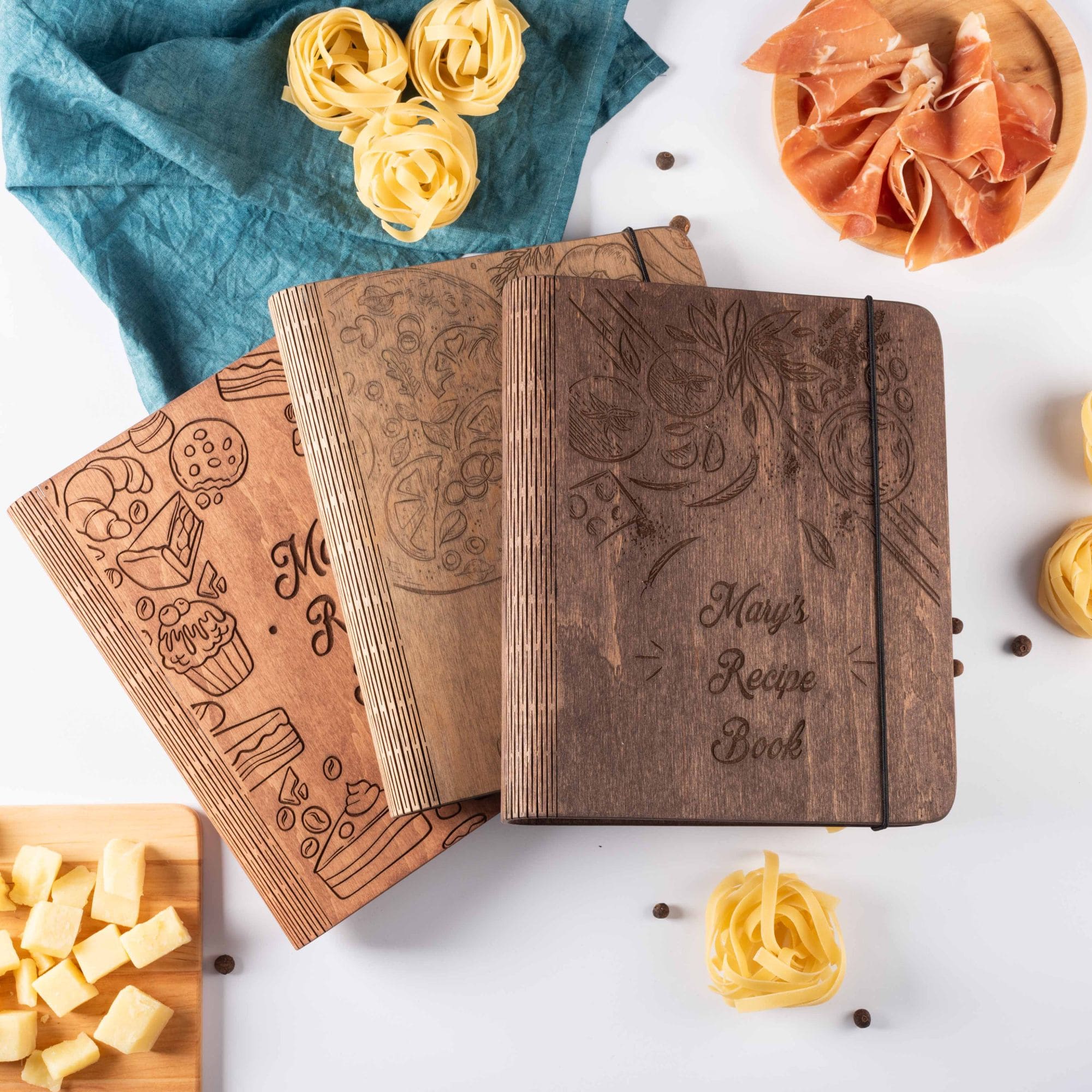 Wooden recipe journals in different styles stacked together