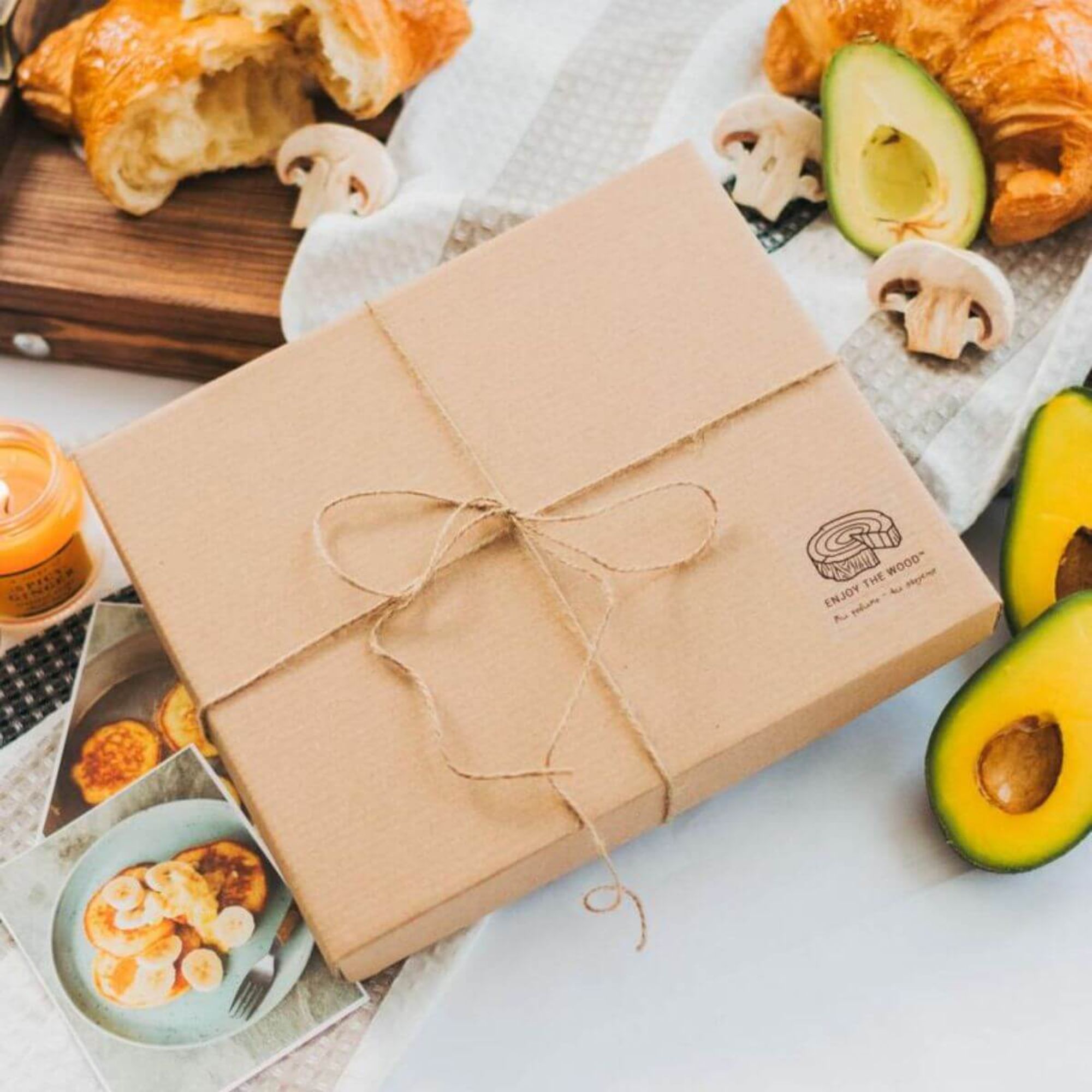 Gift packaging for wooden recipe book with natural eco-friendly cardboard box and twine.