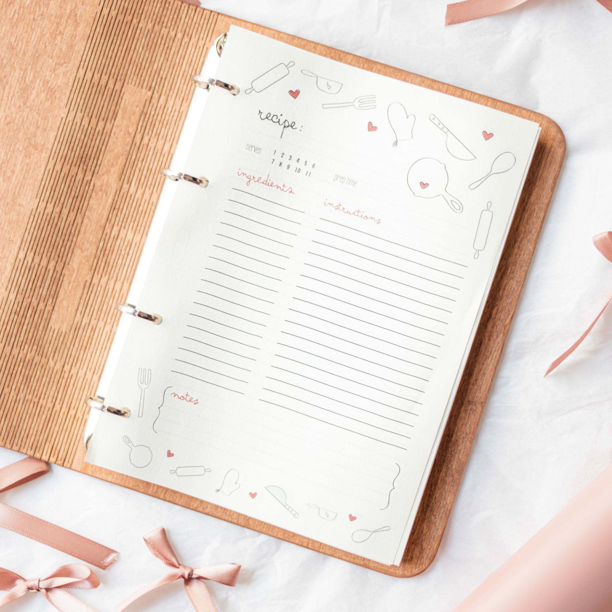 Rustic wooden recipe binder open with blank pages for writing