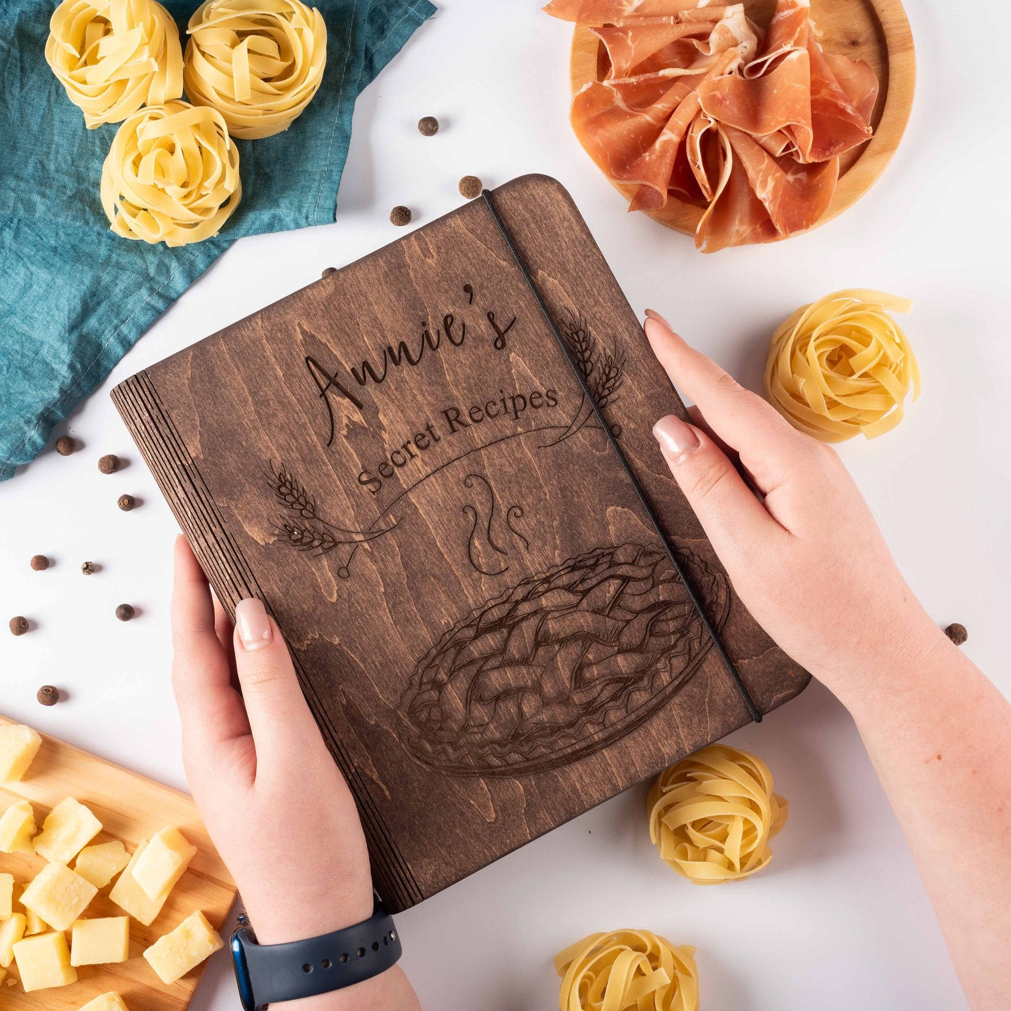Custom engraved dark wooden recipe book with elastic band