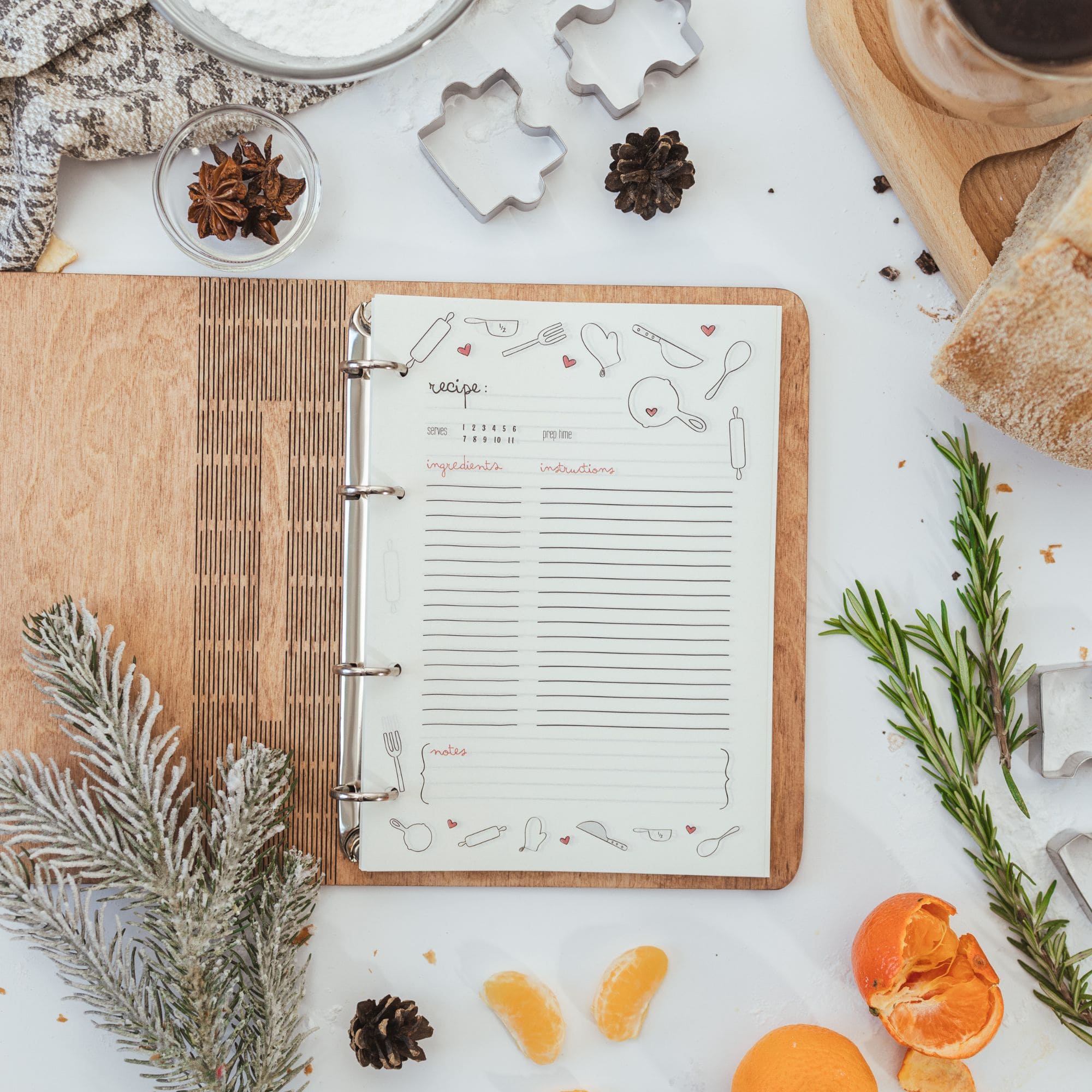 Open wooden recipe notebook with illustrated recipe pages