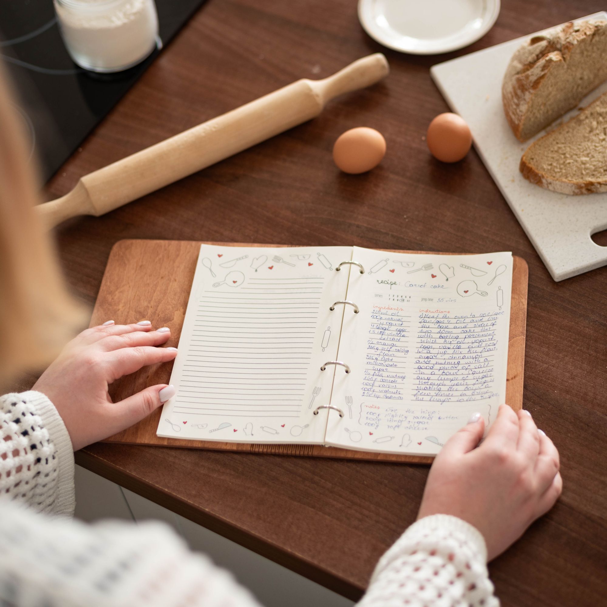 Open wooden recipe book with special recipe pages, handwritten notes inside.