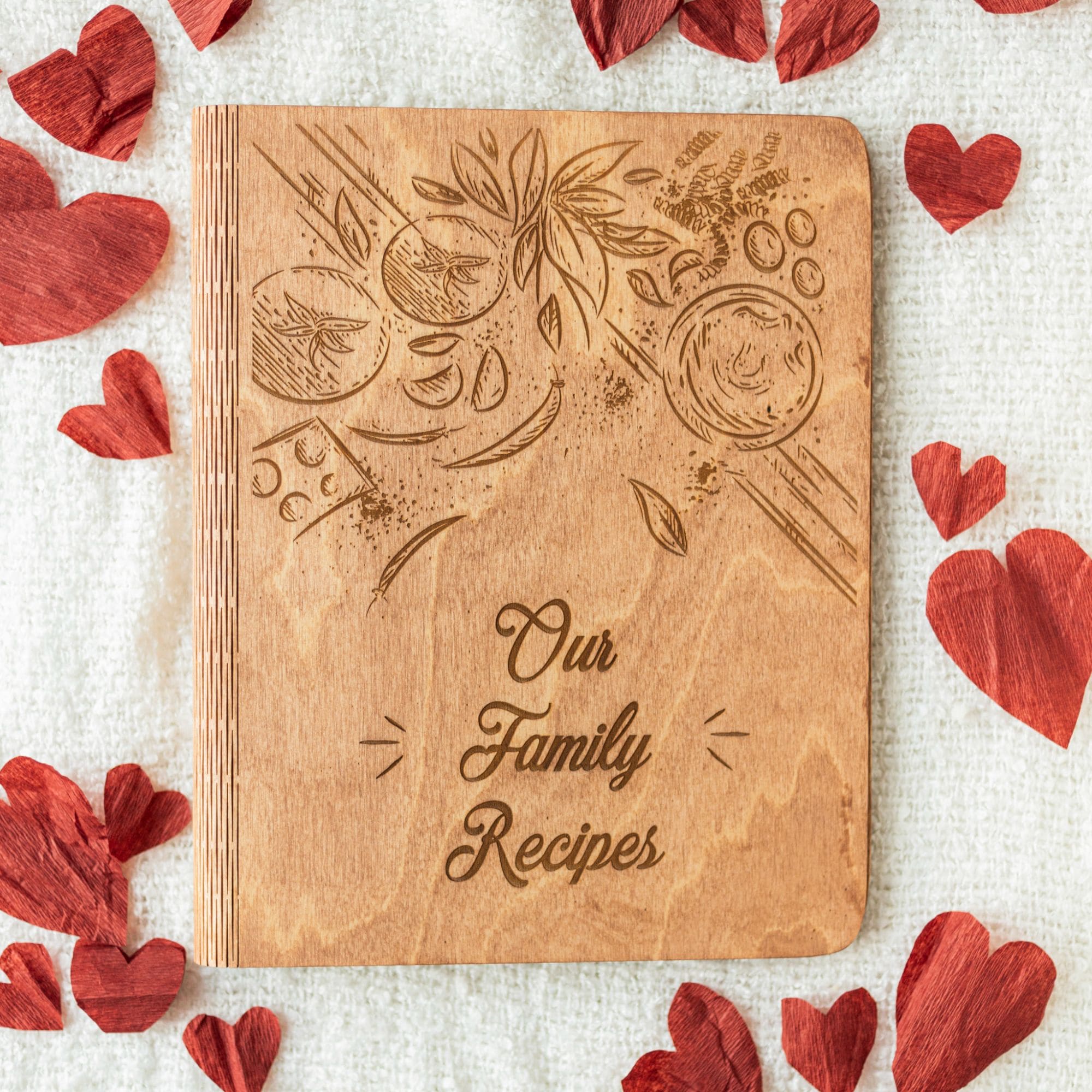 Wooden recipe book engraved with “Our Family Recipes” cover, surrounded by red hearts – personalized cookbook gift