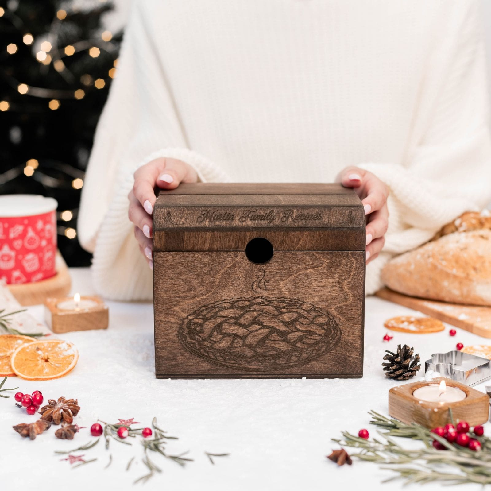 Dark wooden family recipe box on festive holiday table with Christmas decor.