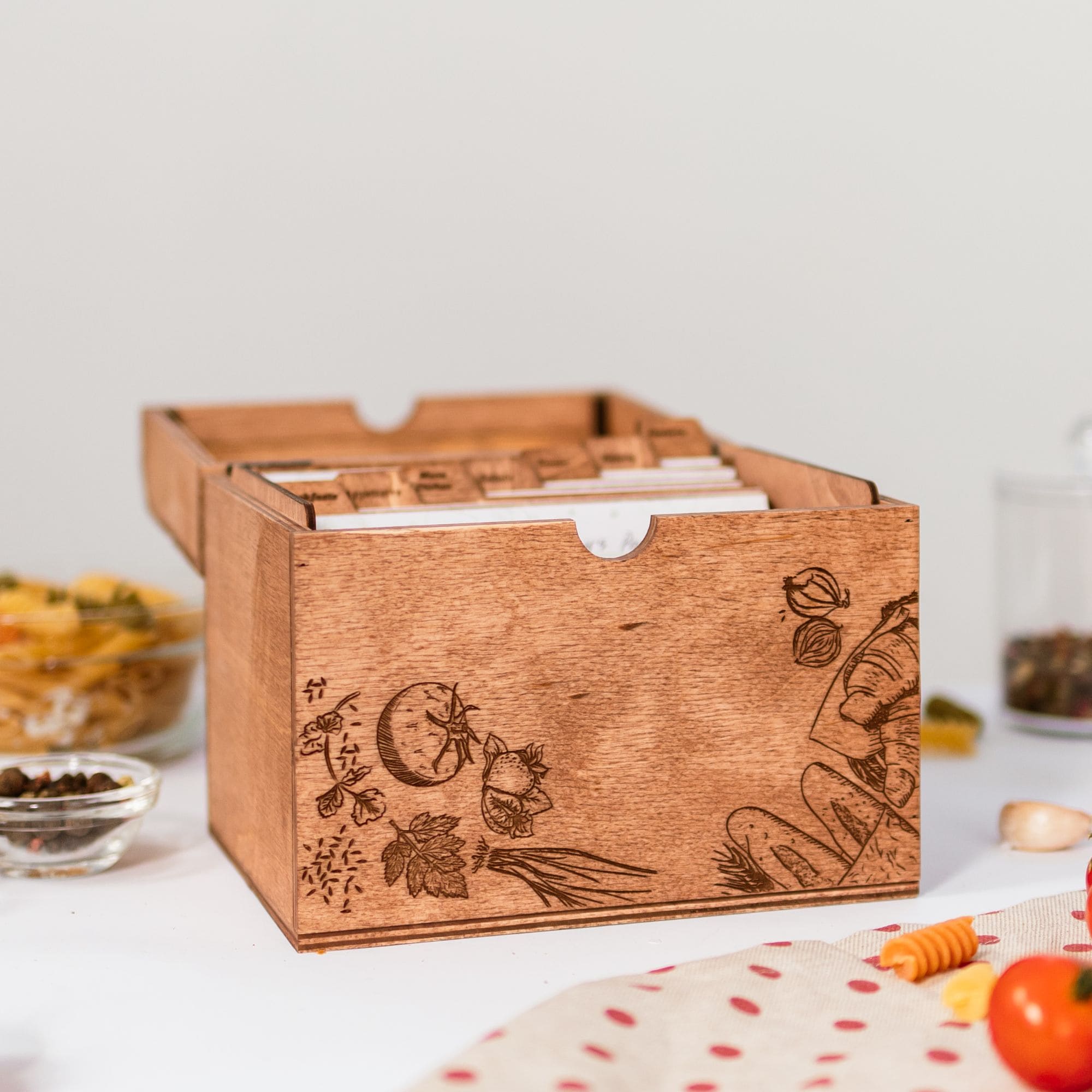 Side view of engraved wooden recipe box with recipe cards inside