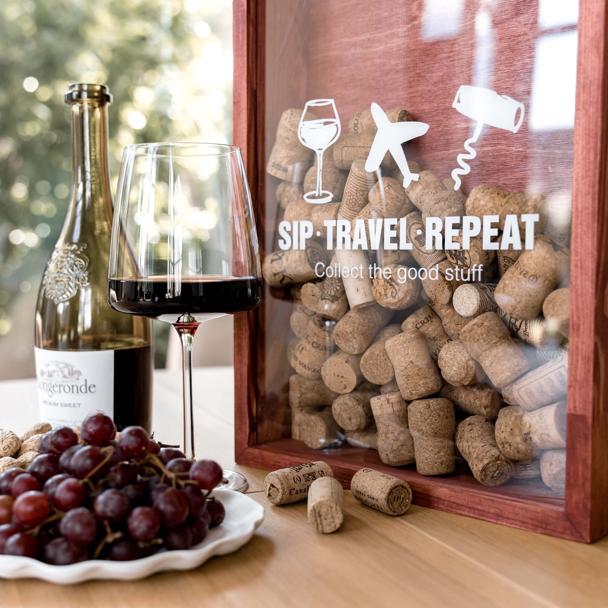 A wooden wine-themed travel cork box