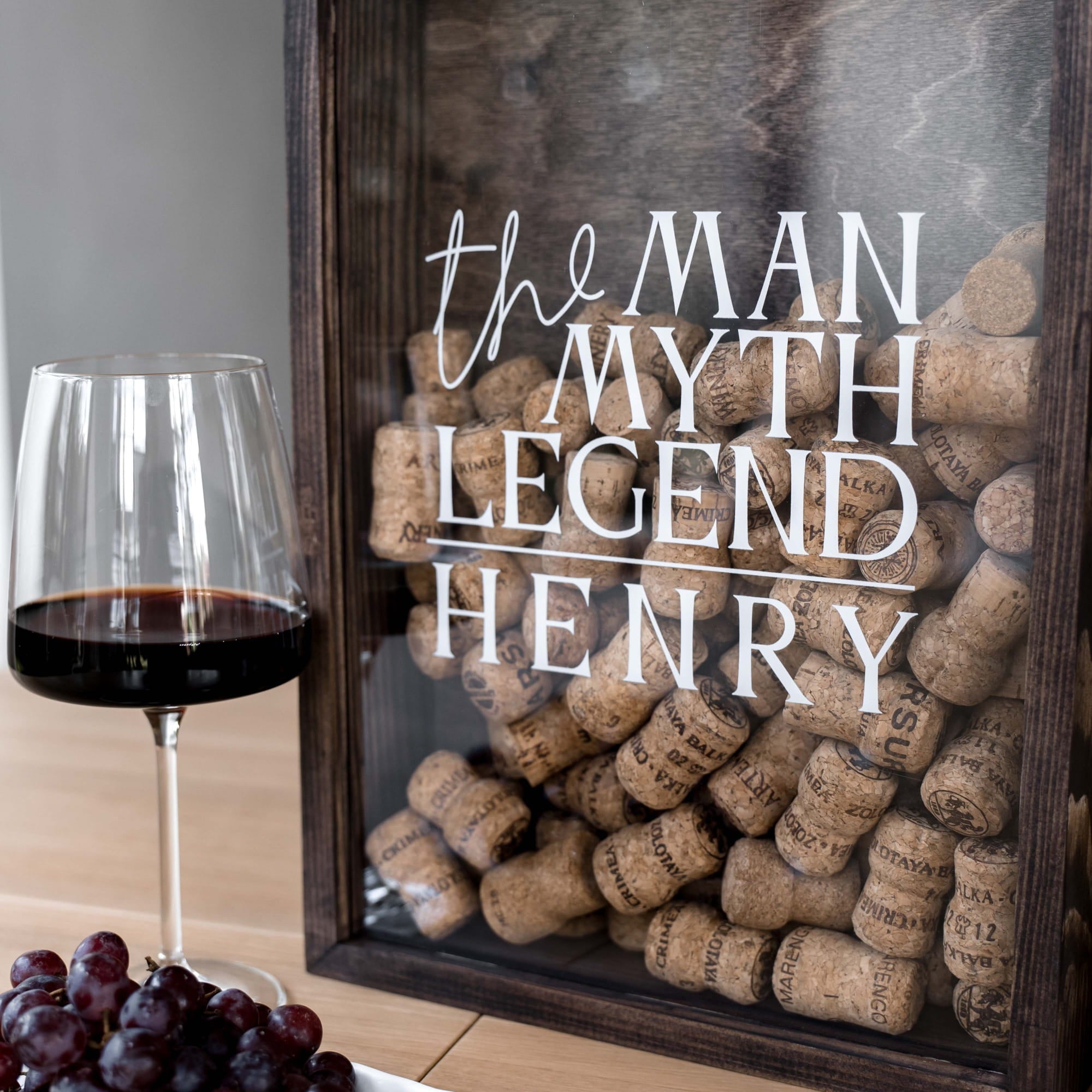 A framed decorative sign filled with wine corks
