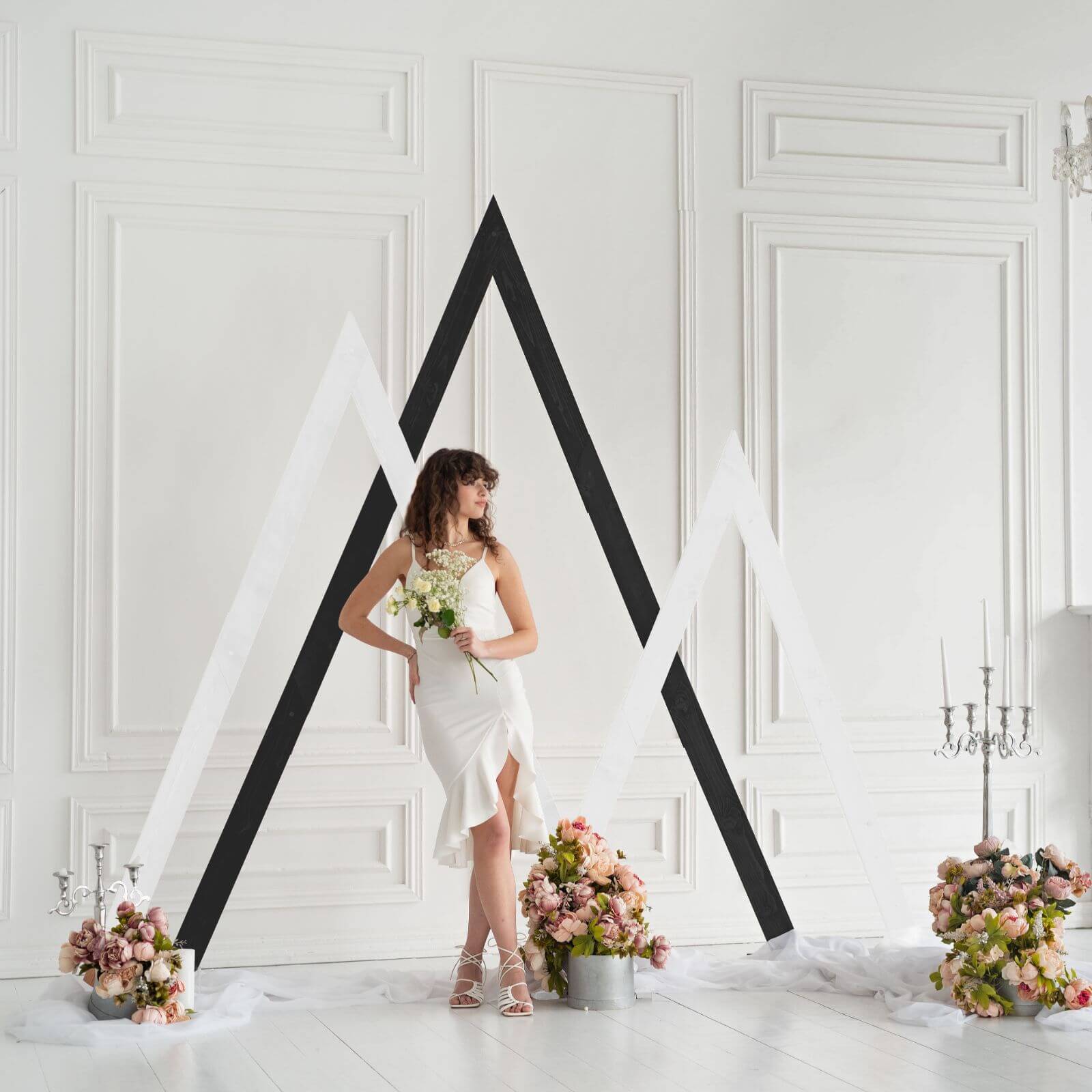 Wedding triangle arches with floral decor and white background.