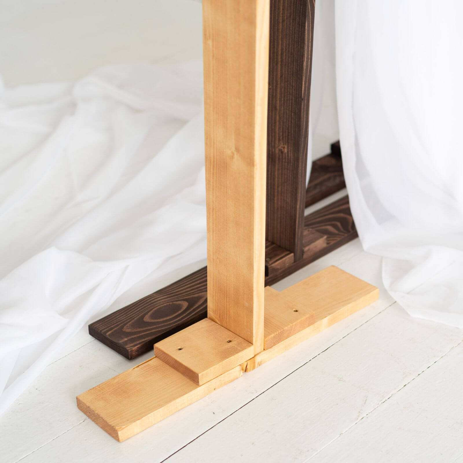 Close-up of wooden pentagon arch sturdy base construction detail.
