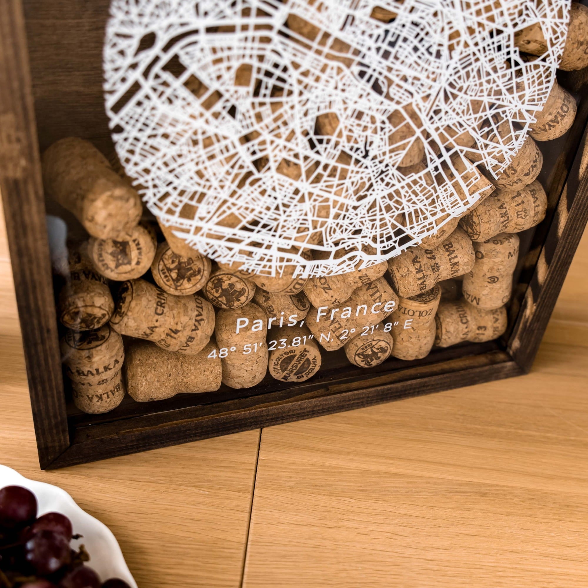A close-up of a wooden shadow box filled with wine corks