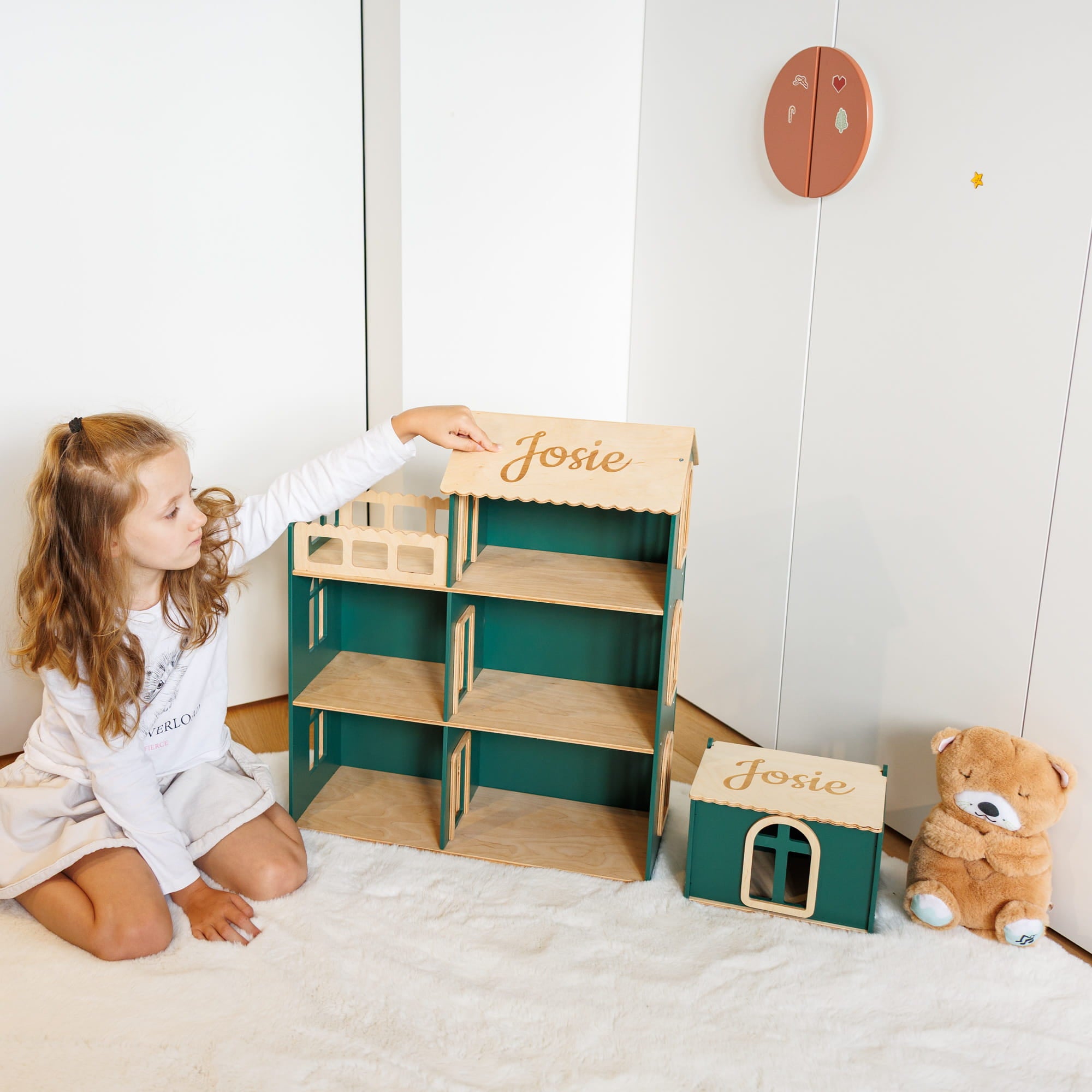 a wooden dollhouse and a small matching storage box