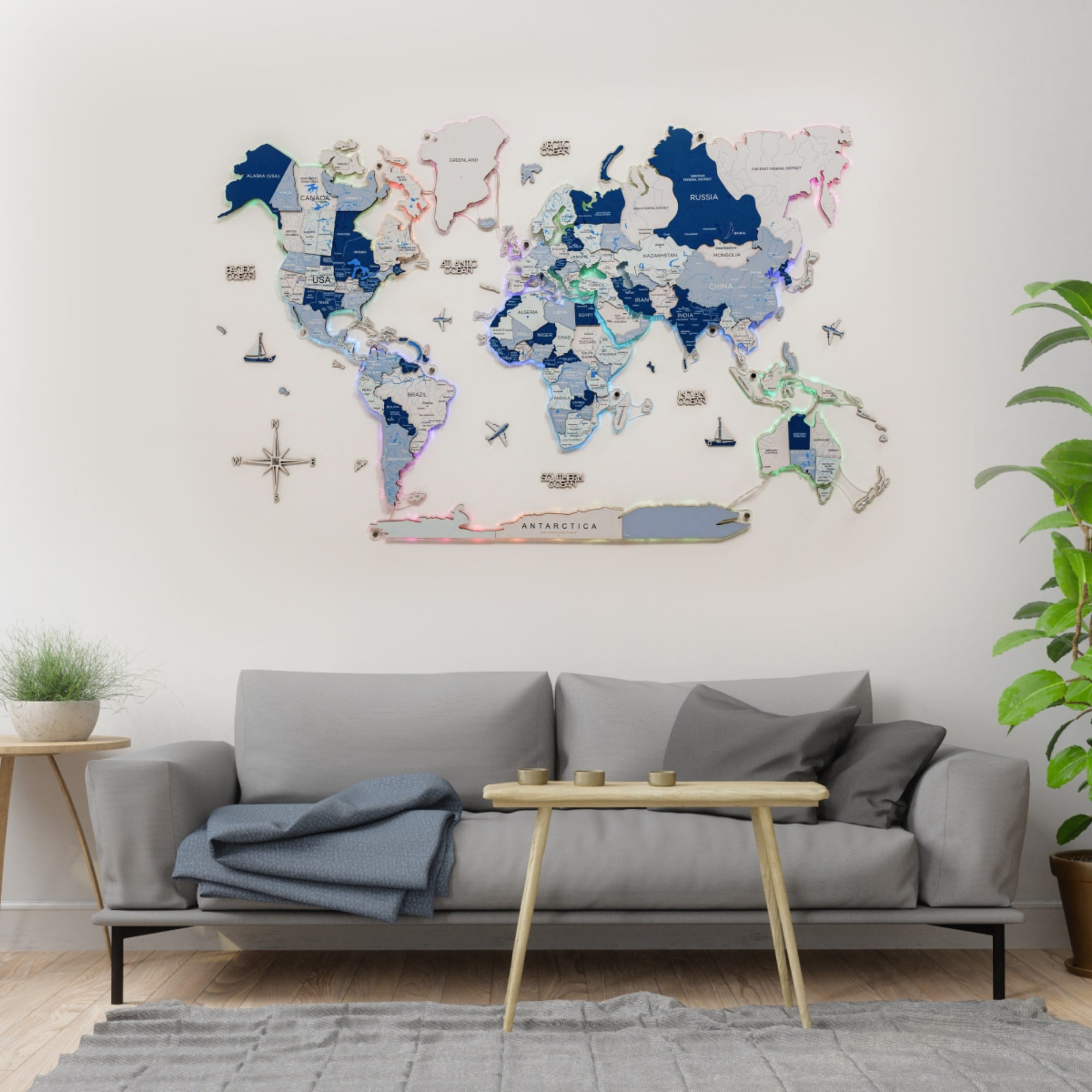 World map on a wall above a gray sofa in a living room.