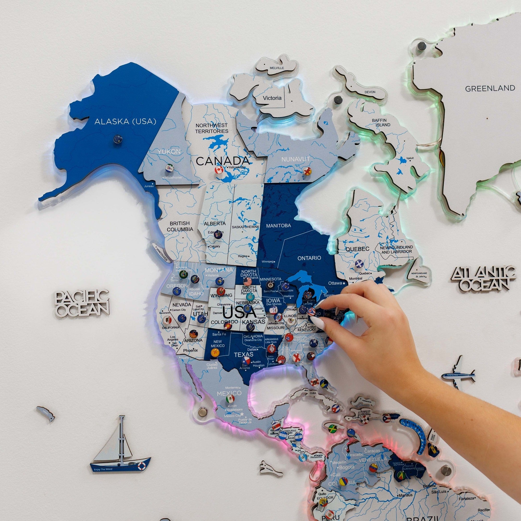 Map of North America with a hand interacting with it on a light gray background